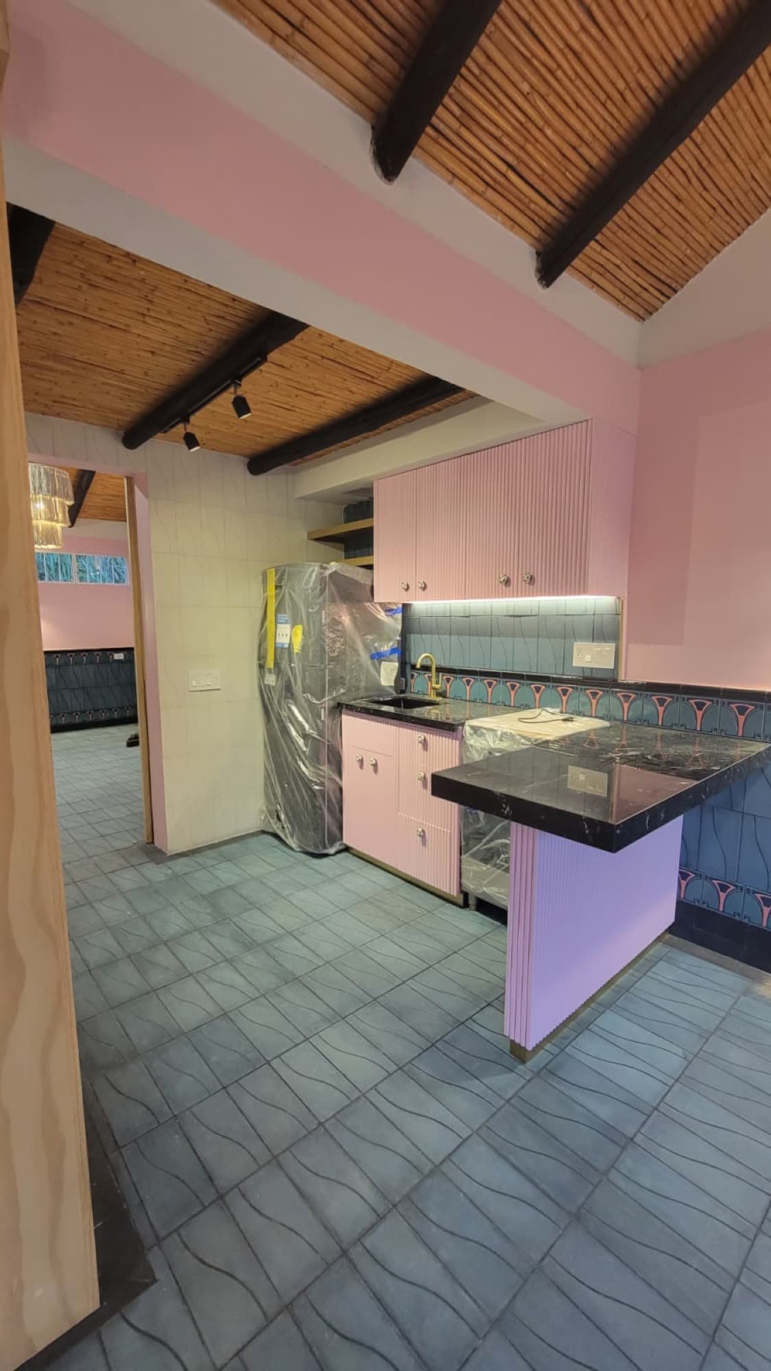 The first unit's new kitchen at Queerhaven, with fluted cabinetry and a stone counter