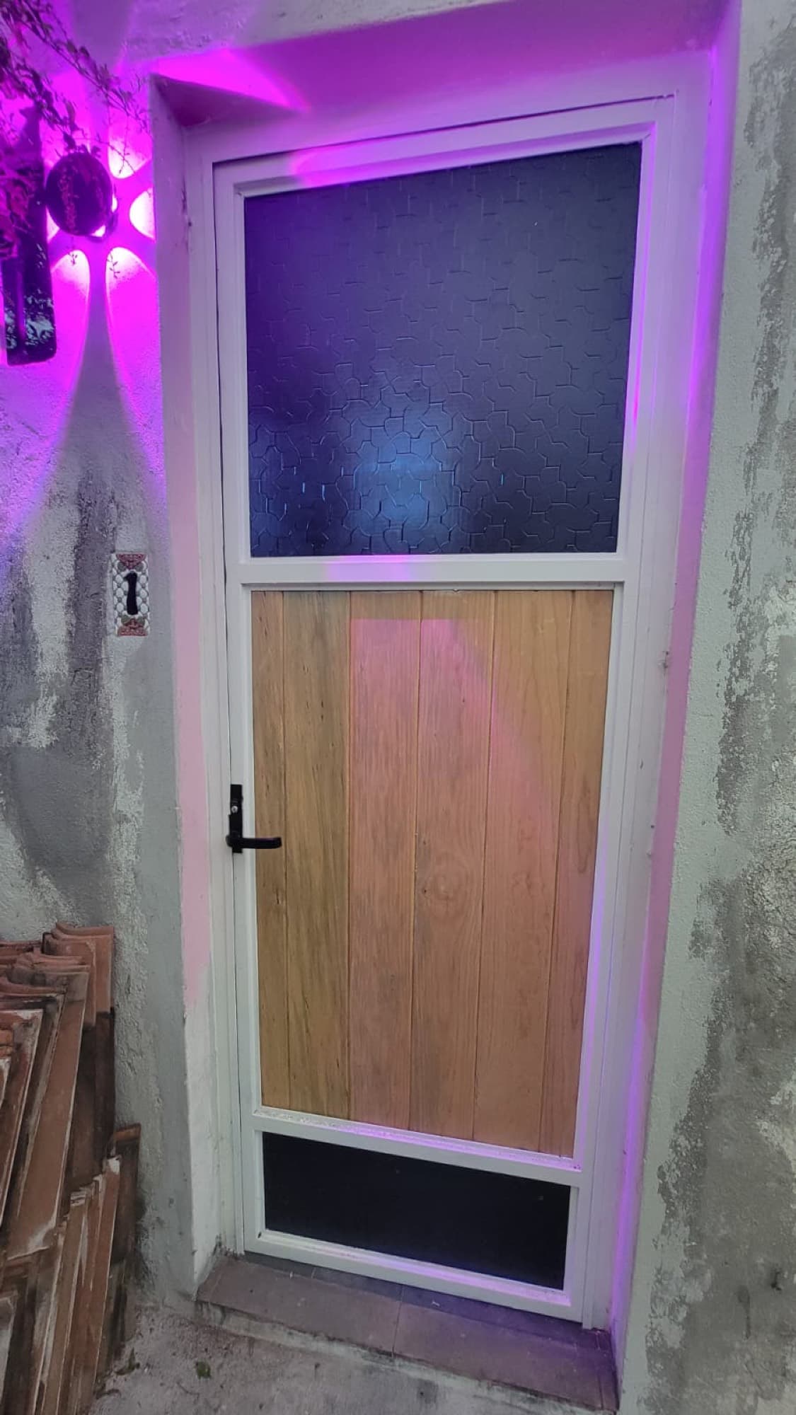 A remodeled bathroom at Queerhaven, seen through a new sliding door