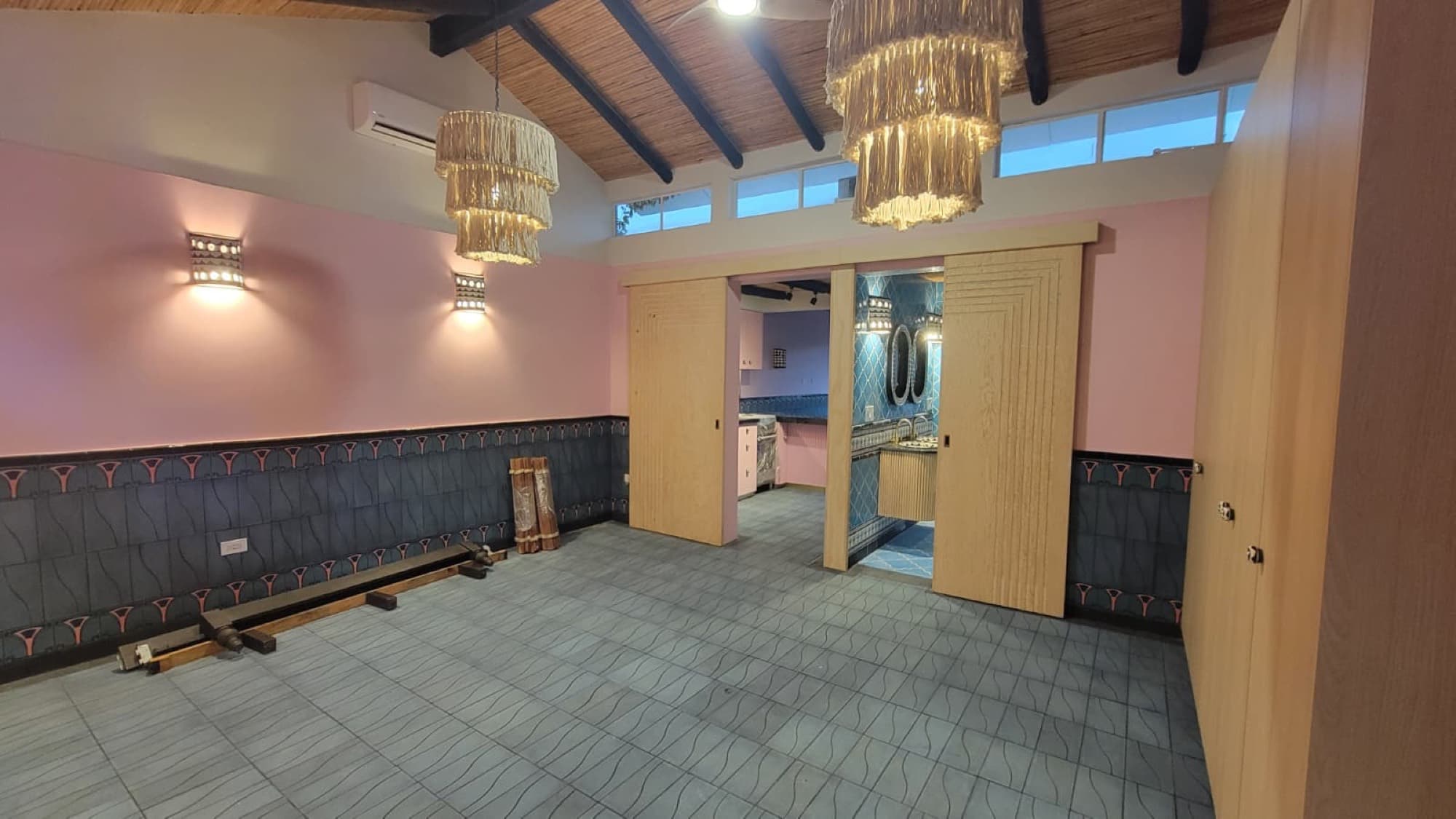 A remodeled room at Queerhaven with restored ceilings and new lighting
