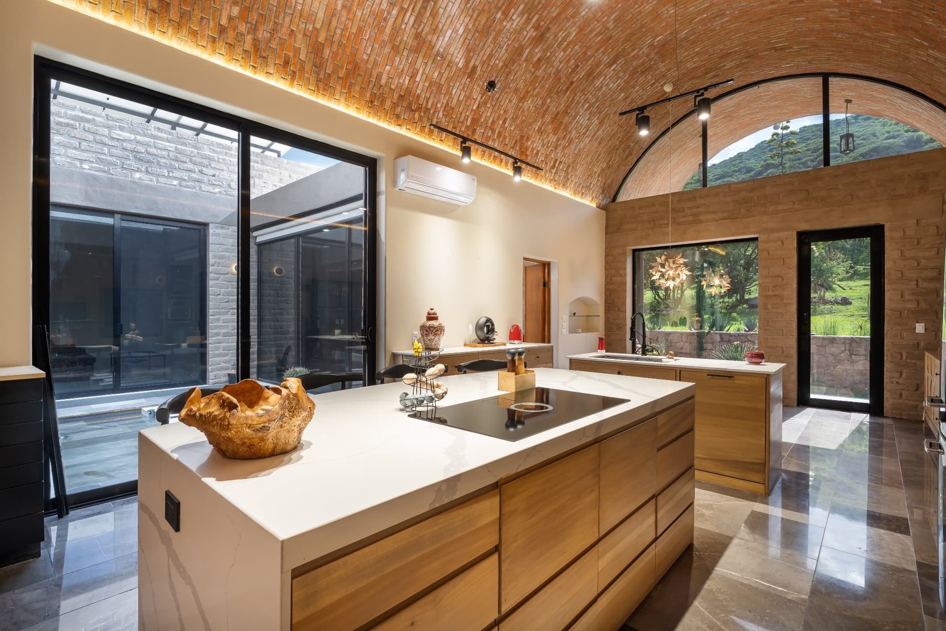 Kitchen at Santuario Eco-Cielo with arched window framing mountain views