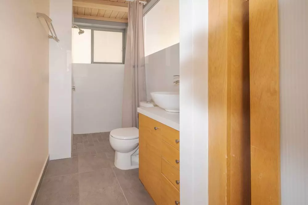 Fraccion 5 — San Antonio, San Miguel de Allende — photo 16 — bright, updated bathroom with warm wood cabinetry