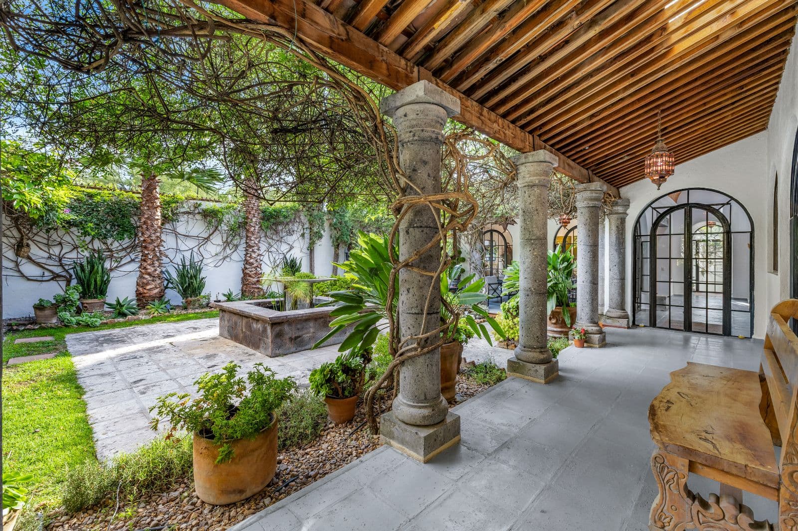 Casa CurVale — Villa de los Frailes, San Miguel de Allende — photo 18 — serene columned courtyard, lush botanical sanctuary