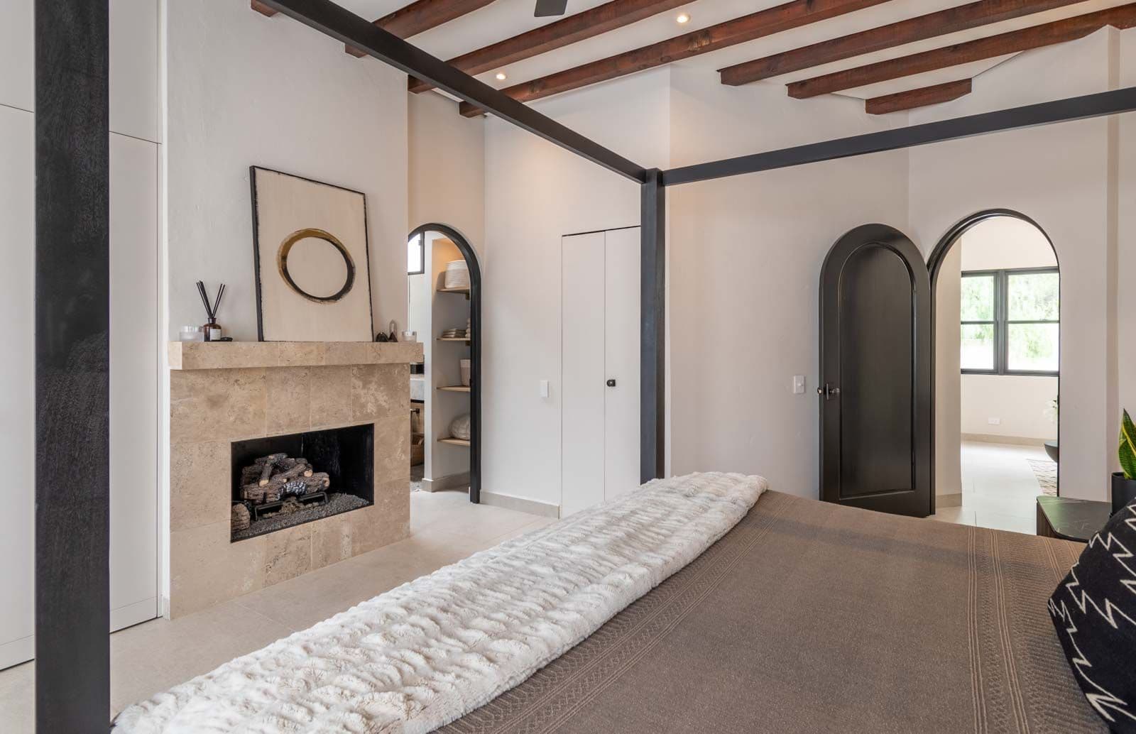 Casa de Luz — Ojo de Agua, San Miguel de Allende — photo 16 — sophisticated primary suite with fireplace elegance