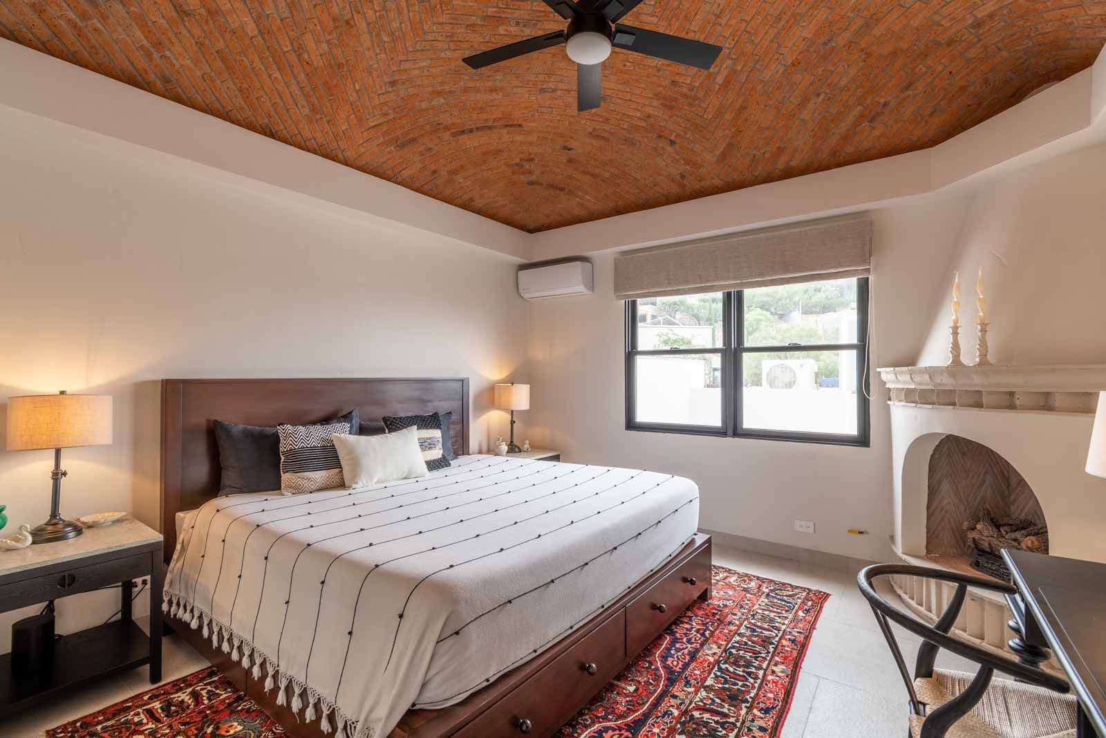 Casa de Luz — Ojo de Agua, San Miguel de Allende — photo 18 — rustic-chic master suite with fireplace