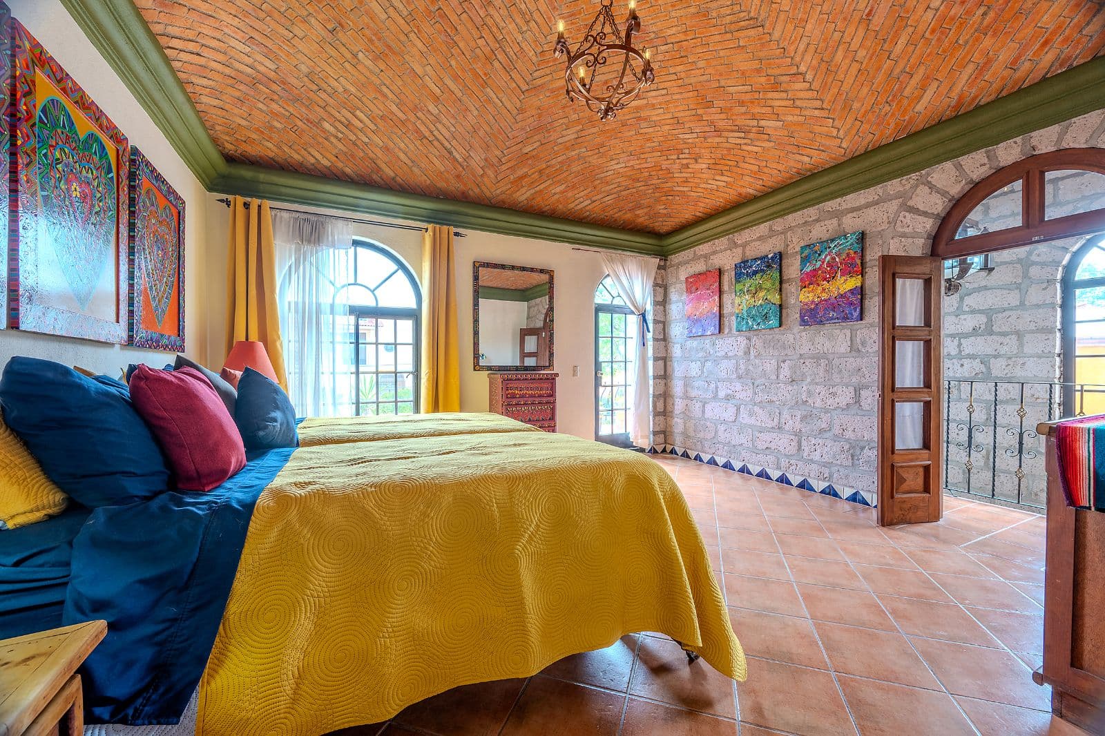 Casa Colorida — Villa de los Frailes, San Miguel de Allende — photo 17 — vibrant hacienda bedroom with soaring brick ceilings