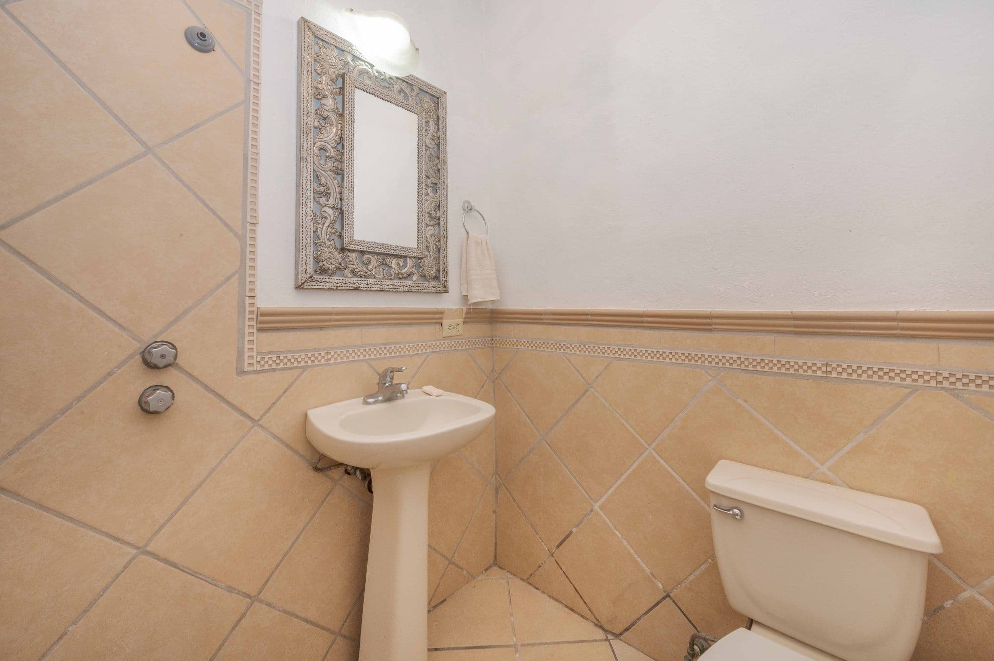 Casa Azul Escondida — San Antonio, San Miguel de Allende — photo 6 — elegant half bath with ornamental mirror