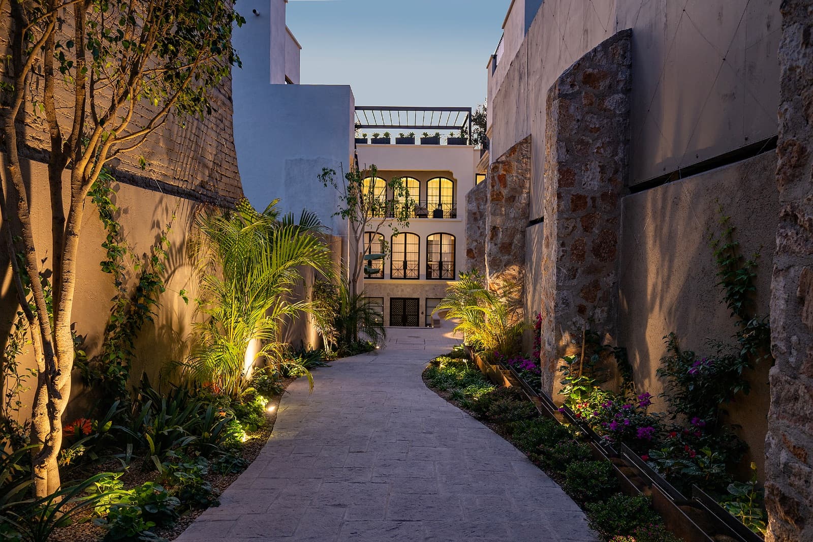 3 · Luxury Penthouse 2 Bedrooms with Private Rooftop - Paseo del Centro — Centro, San Miguel de Allende — photo 19 — enchanting courtyard, ambient evening glow