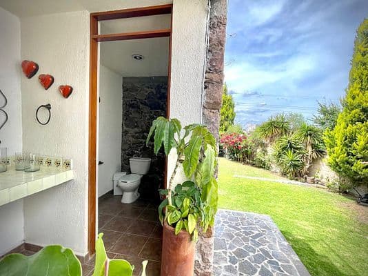CASA AGAVE — Villa de los Frailes, San Miguel de Allende — photo 12 — charming outdoor bath, verdant garden views