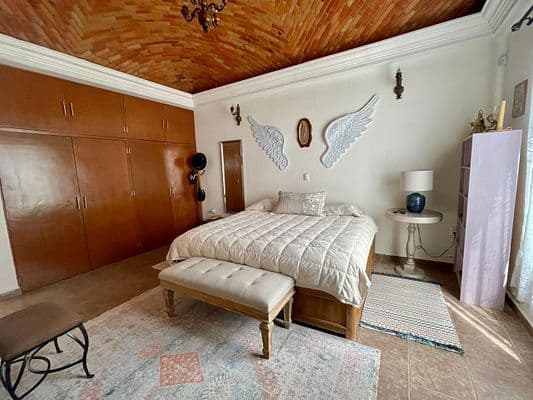CASA AGAVE — Villa de los Frailes, San Miguel de Allende — photo 21 — serene master suite, soaring wood ceiling