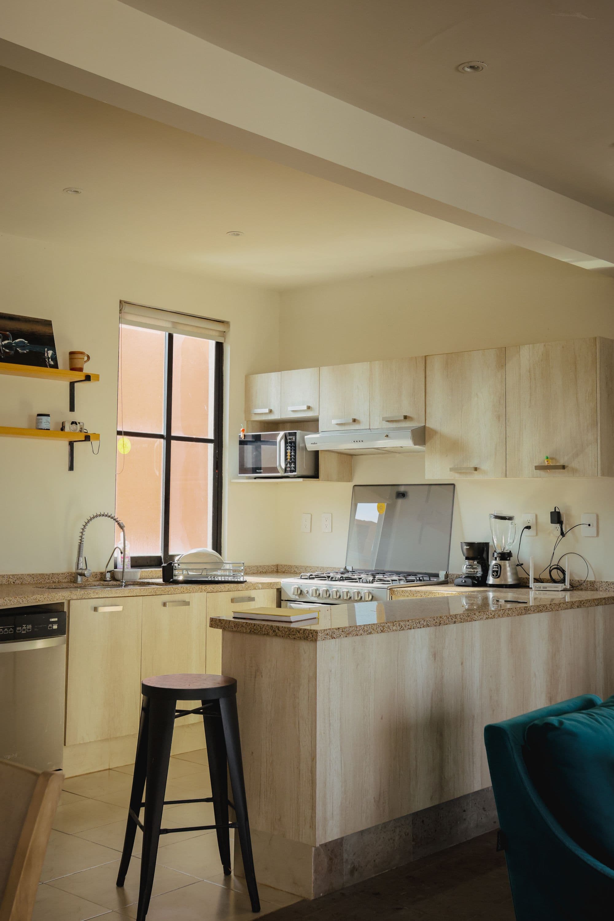 El Milagro Rooftop Apartment — San Miguel de Allende Centro, San Miguel de Allende — photo 3 — luminous contemporary kitchen, soaring ceilings