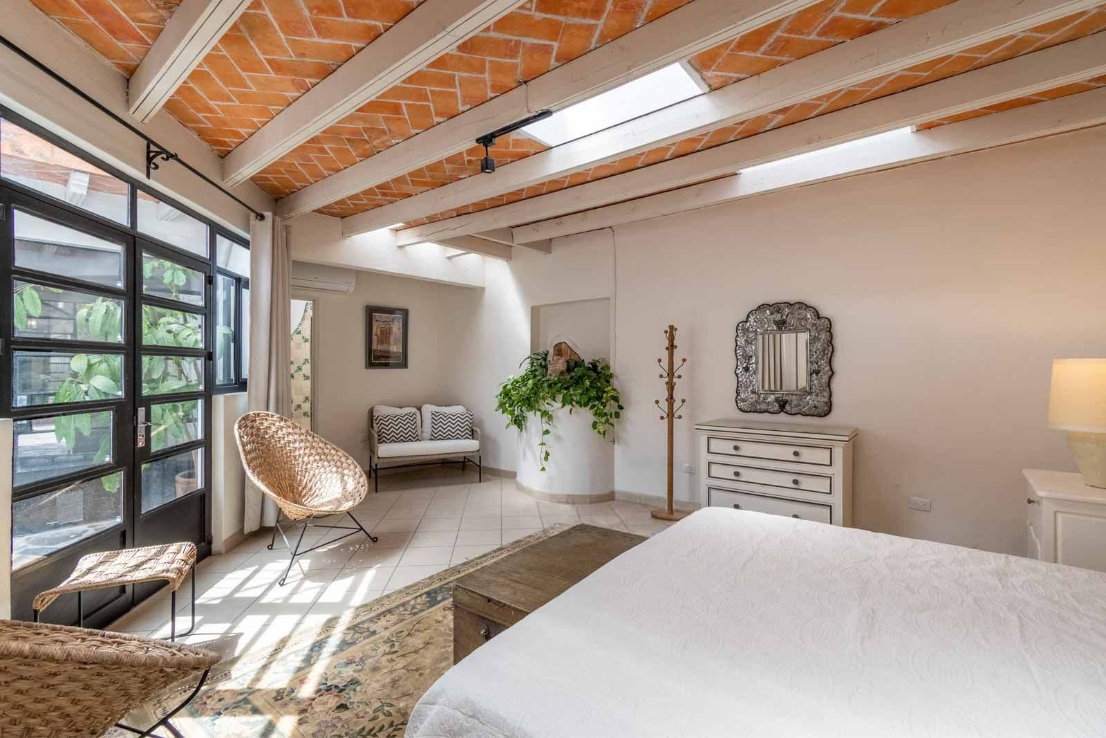 Casa Quebrada — Centro, San Miguel de Allende — photo 16 — sun-drenched bedroom with soaring beams