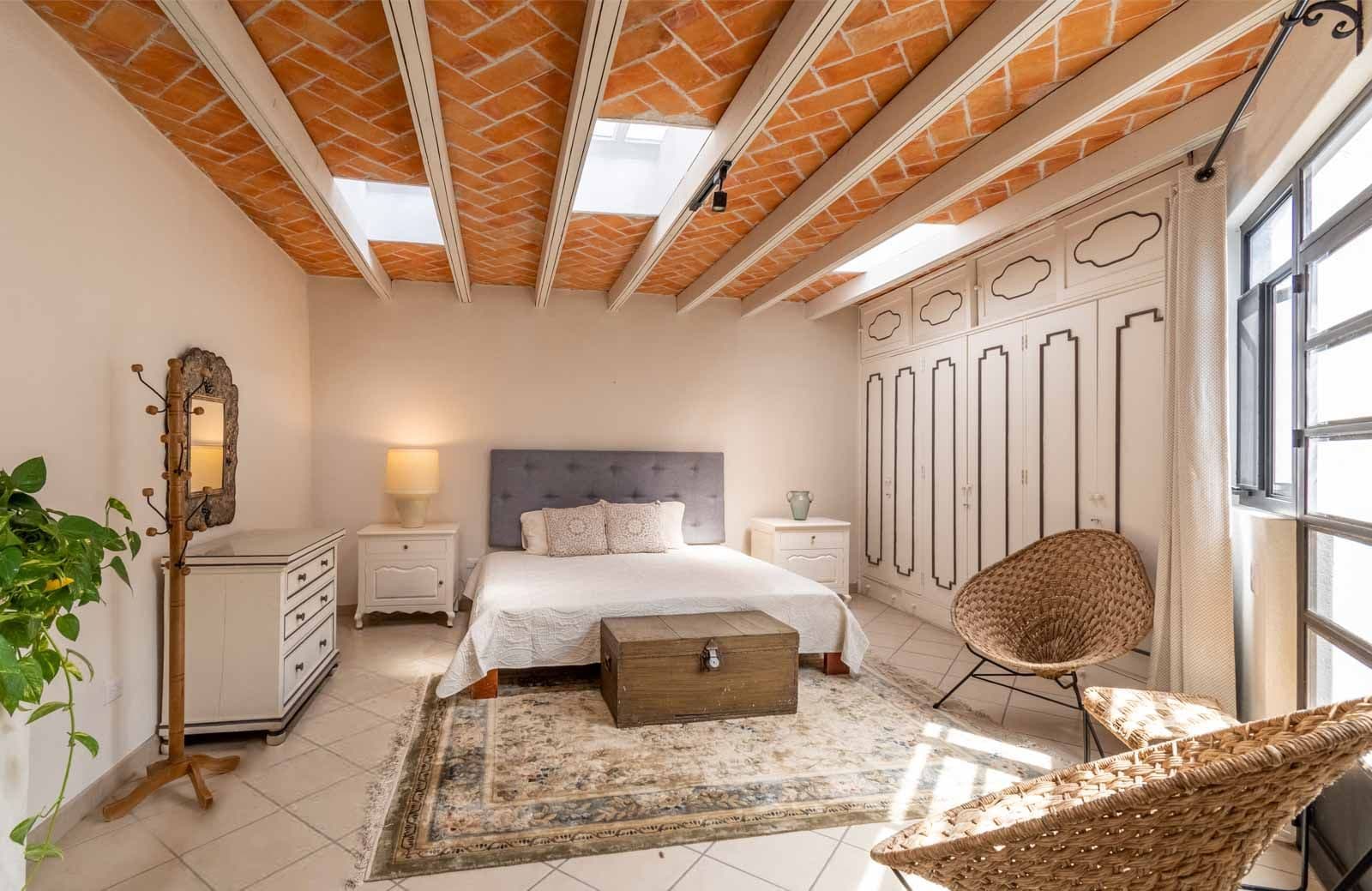 Casa Quebrada — Centro, San Miguel de Allende — photo 15 — luminous master suite, exposed brick beams