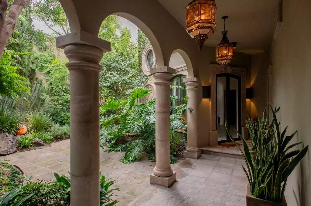 Casa Lyla — Balcones, San Miguel de Allende — photo 5 — columned arcade, lush courtyard oasis