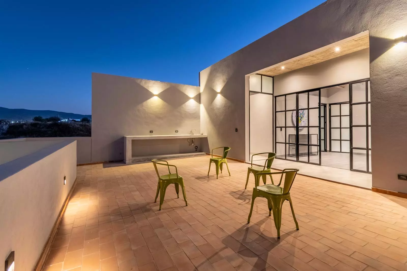 Brut House — San Antonio, San Miguel de Allende — photo 22 — twilight terrace with architectural elegance