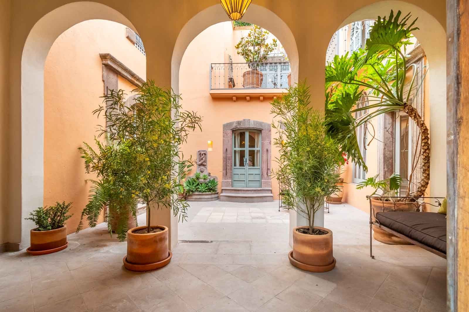 Casa Recreo — Centro, San Miguel de Allende — photo 3 — sun-drenched courtyard, soaring arches, verdant sanctuary