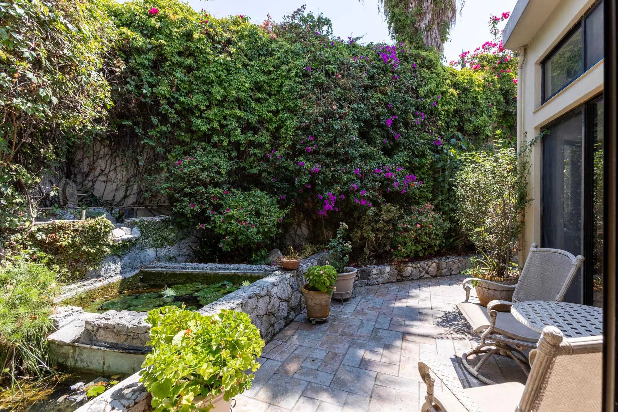 Exquisite Home in Prime San Miguel de Allende Location — Guadiana, San Miguel de Allende — photo 14 — lush courtyard oasis with serene pond