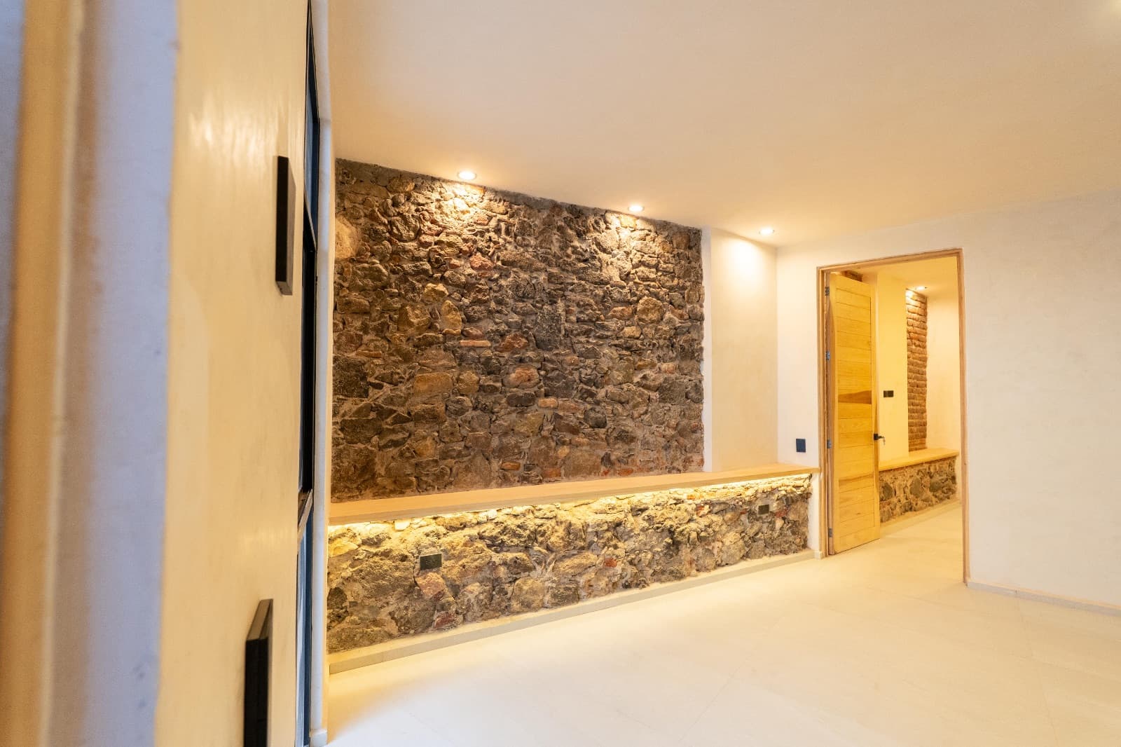 Nuñez Lofts / Loft 2 — Centro, San Miguel de Allende — photo 2 — rustic stone wall, elegant ambient lighting
