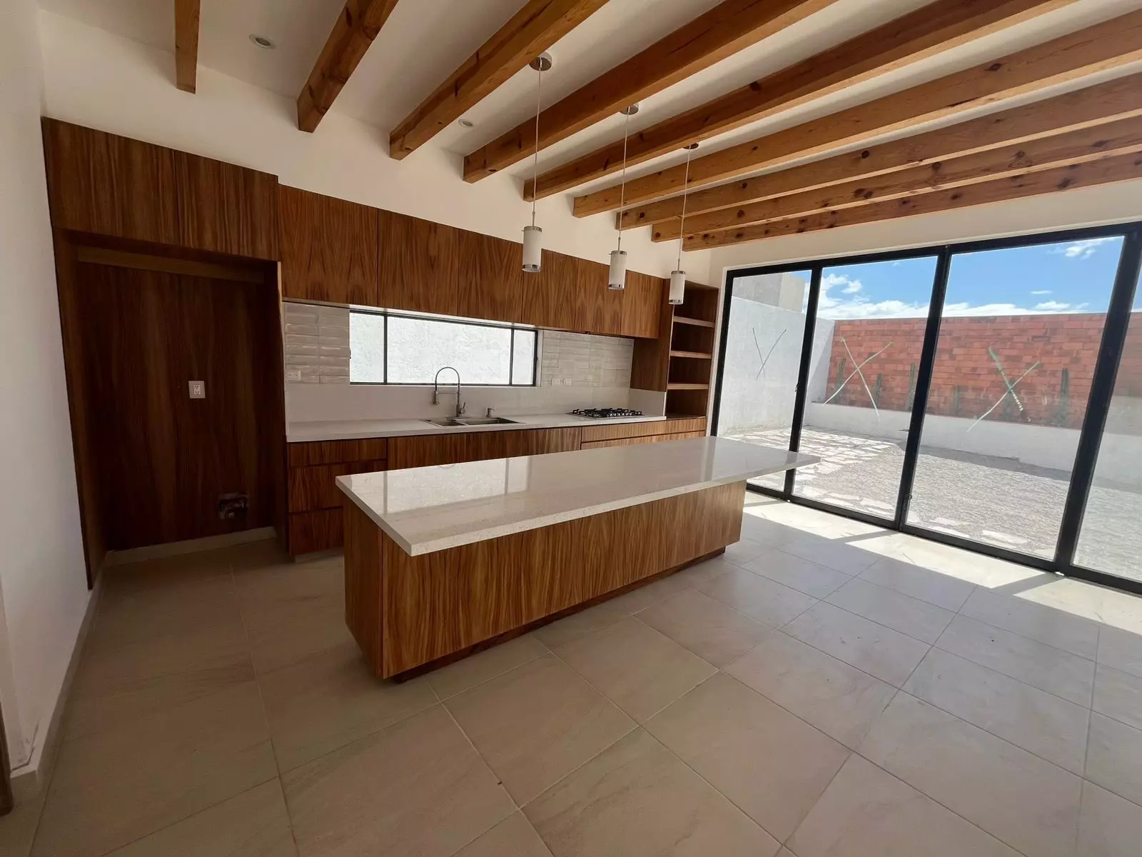 CASA LEO — Residencial Malanquin la Mesa, San Miguel de Allende — photo 5 — contemporary chef's kitchen with soaring beams
