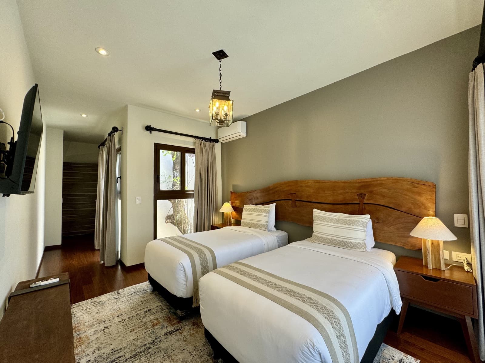 Quinta Tenerías (Units 2, 4 & 5) — Centro, San Miguel de Allende — photo 15 — elegant twin bedroom, warm wood details