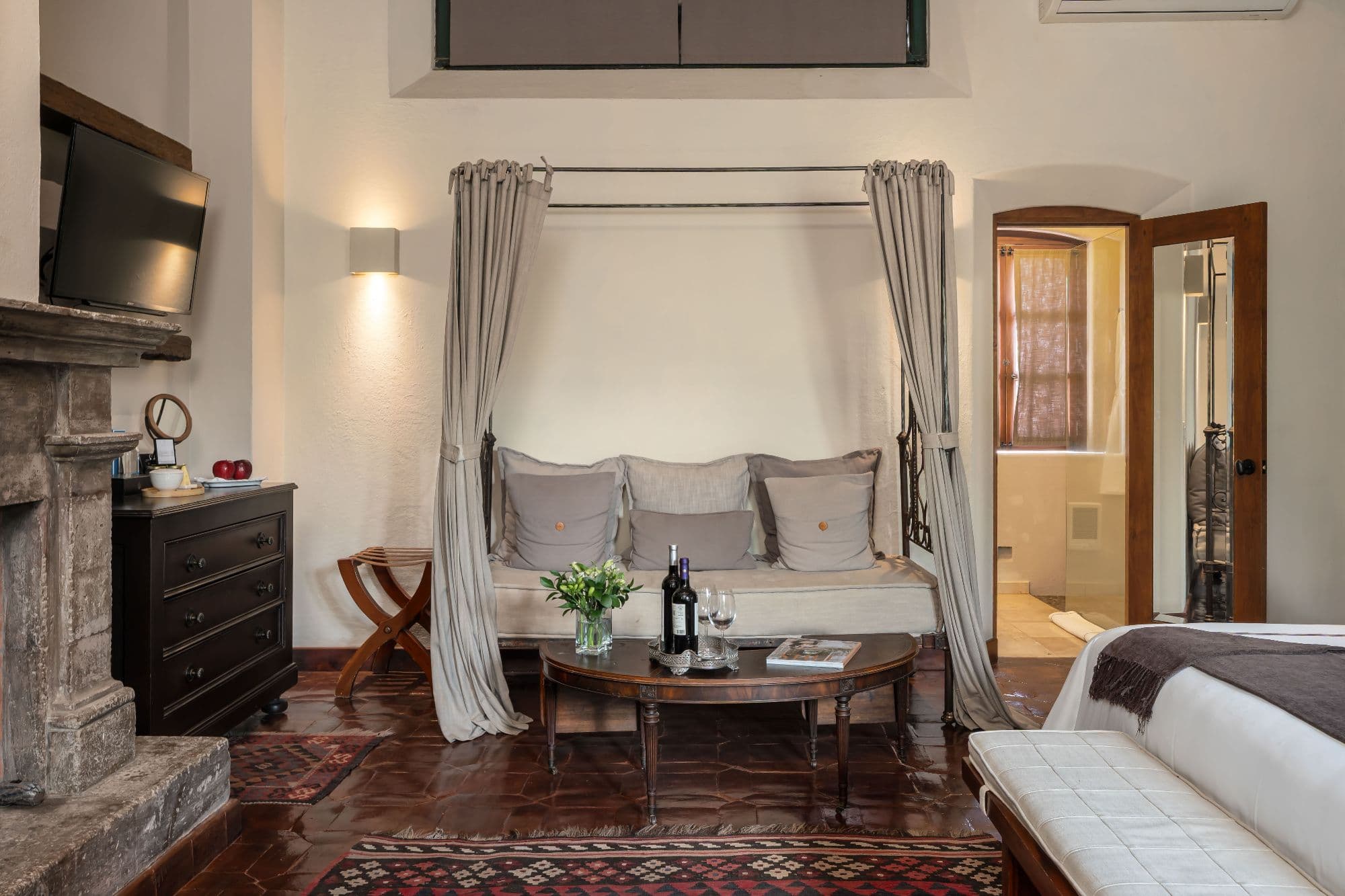 Casa No Name — Centro, San Miguel de Allende — photo 37 — elegant canopied bedroom with fireplace
