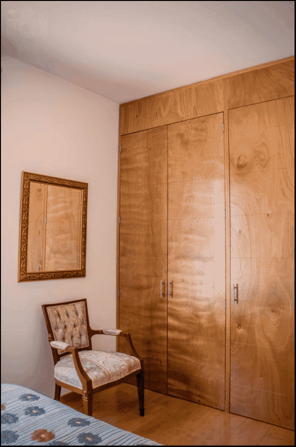 Casa Garzas — Las Brisas, San Miguel de Allende — photo 19 — warm wood cabinetry, refined bedroom elegance