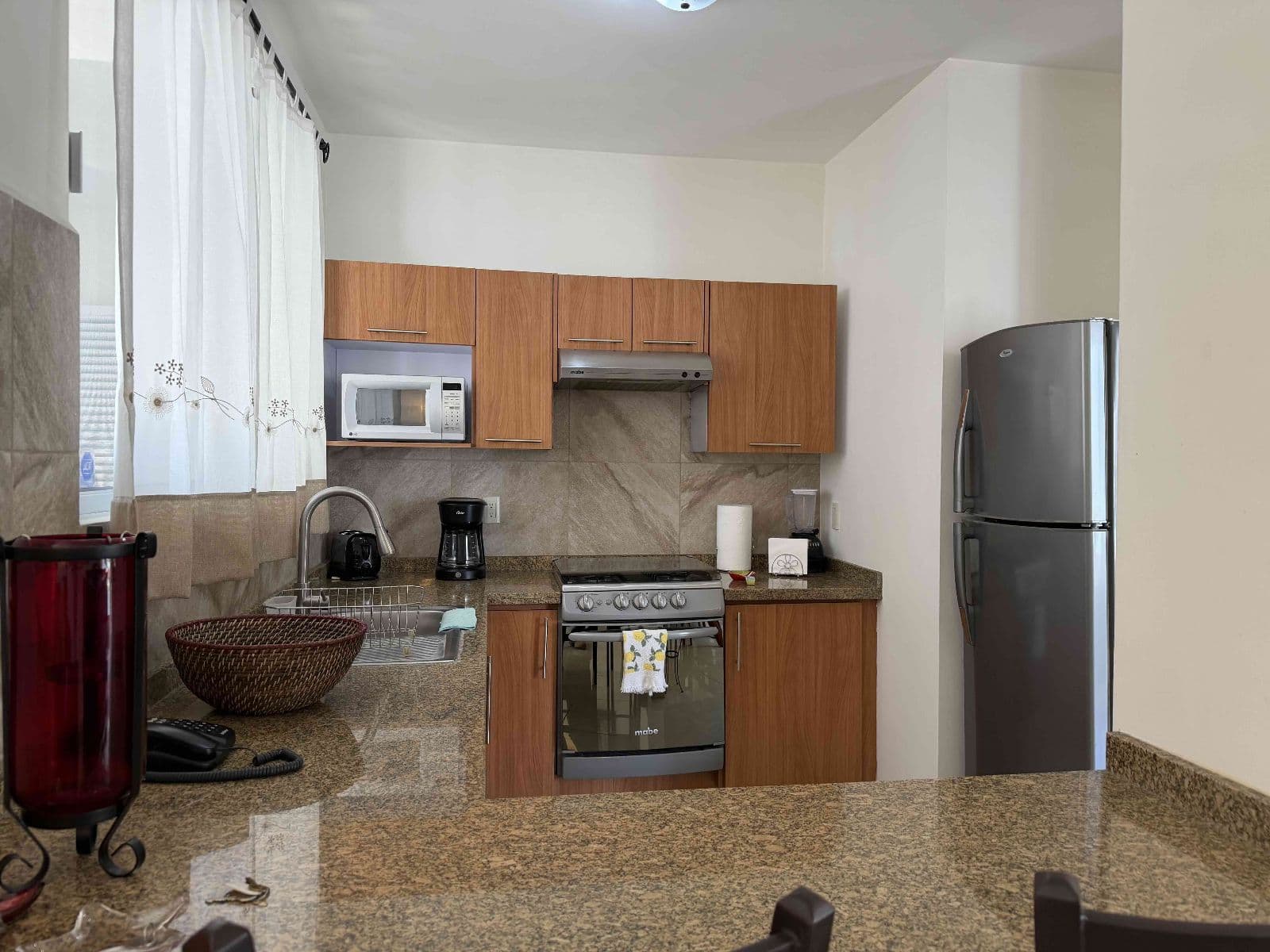 Casa Garzas — Las Brisas, San Miguel de Allende — photo 3 — modern equipped kitchen, warm wood cabinetry