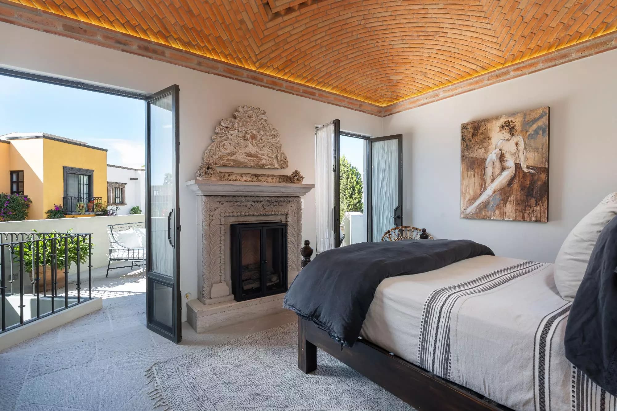 Casa Dos Casas — Guadiana, San Miguel de Allende — photo 32 — elegant master suite, fireplace, terrace views