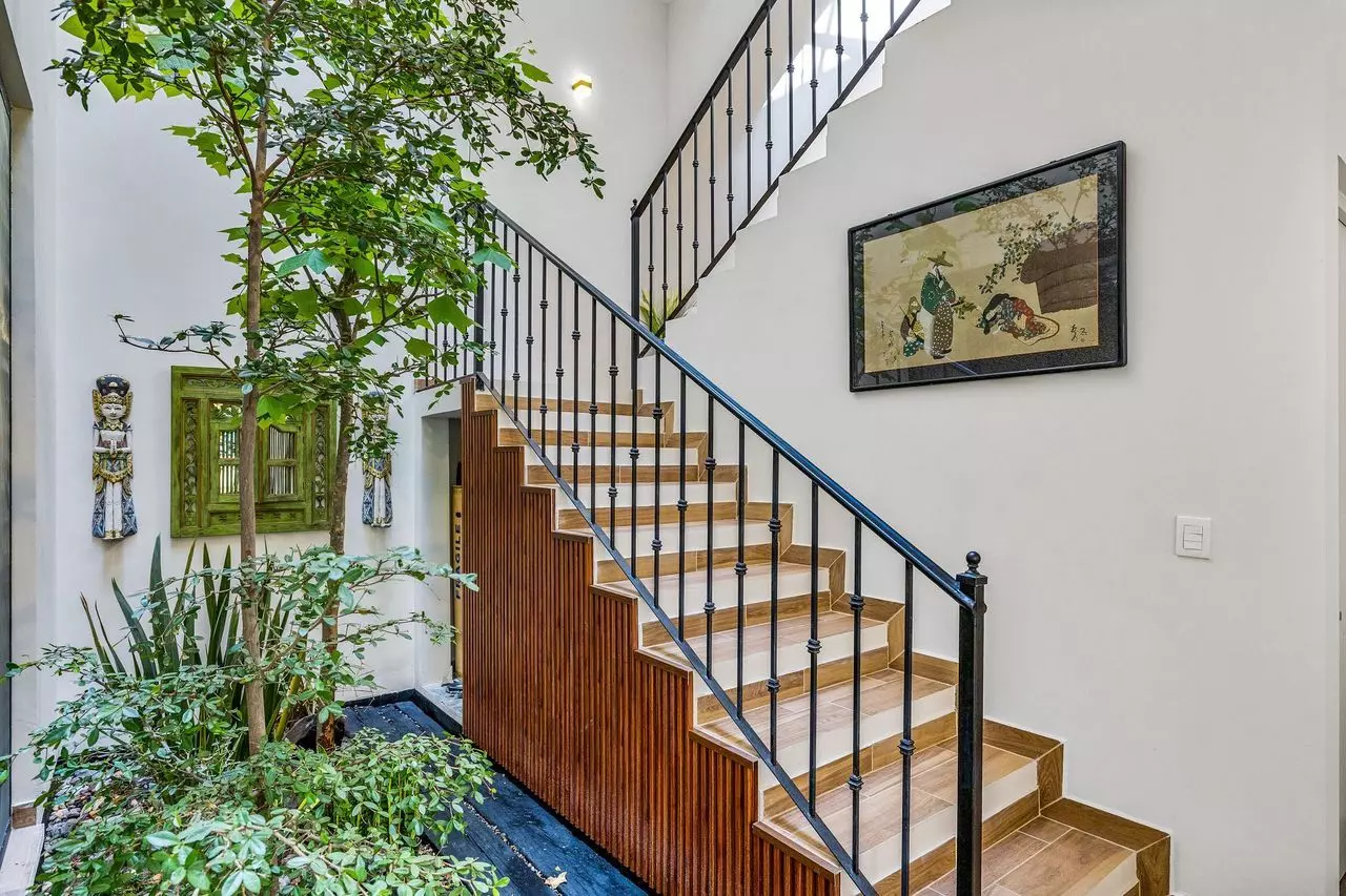 Casa Angel — La Lejona, San Miguel de Allende — photo 15 — elegant staircase, verdant interior courtyard