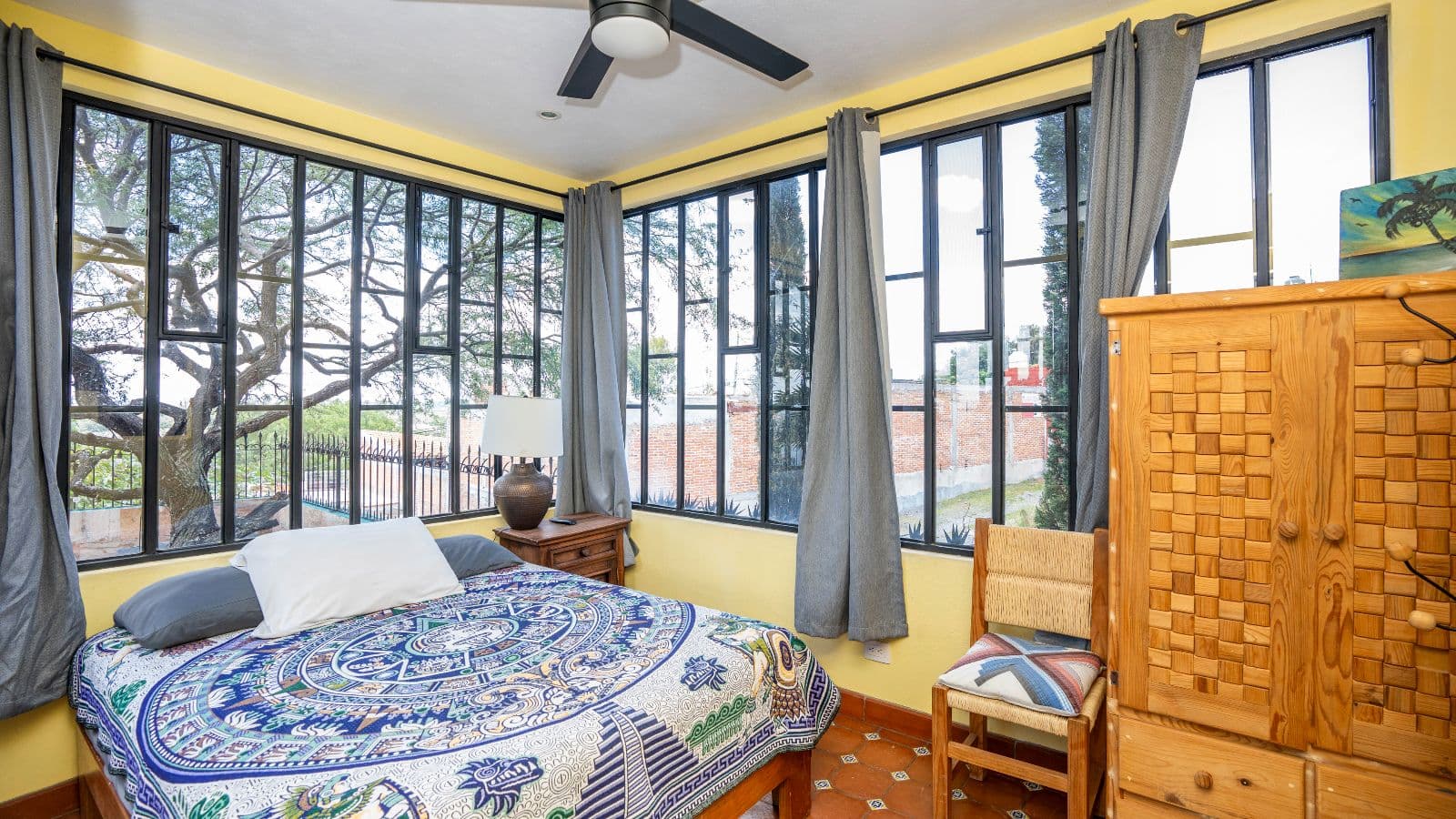 Casa de Tomas — La Lomita, San Miguel de Allende — photo 11 — sunlit bedroom with verdant garden views