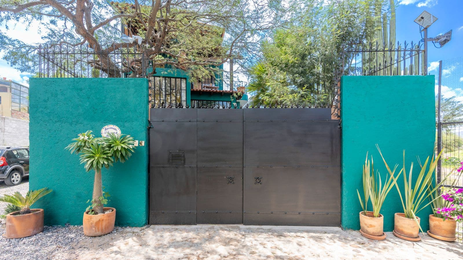 Casa de Tomas — La Lomita, San Miguel de Allende — photo 26 — vibrant courtyard entry, mature garden sanctuary