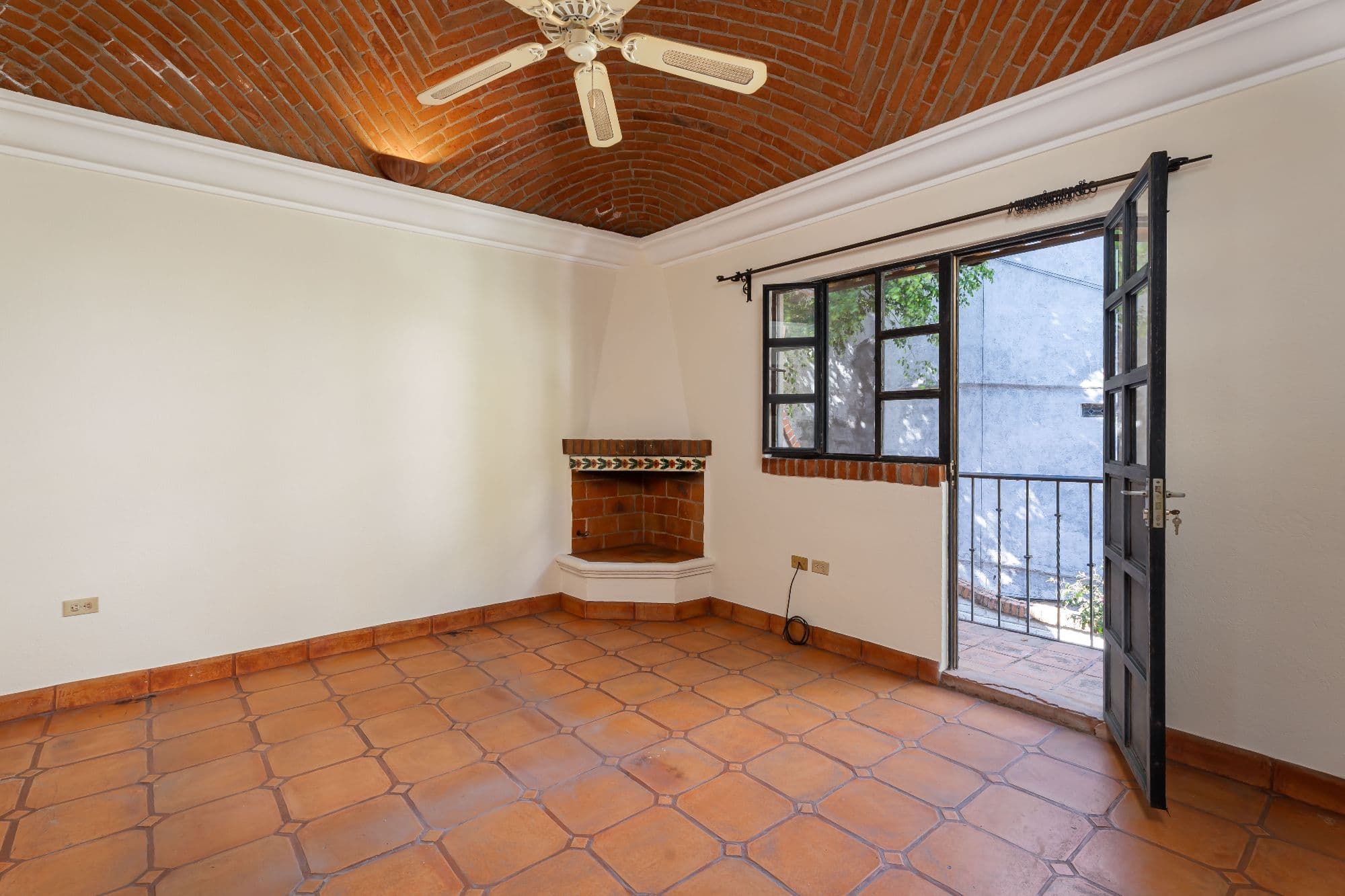 Casa Hidden Nook — San Antonio, San Miguel de Allende — photo 17 — luminous corner fireplace, authentic terracotta charm