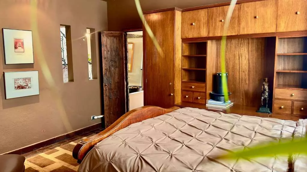 La Raiz De Las Nubes Los Balcones — Balcones, San Miguel de Allende — photo 4 — elegant master suite, warm wood cabinetry