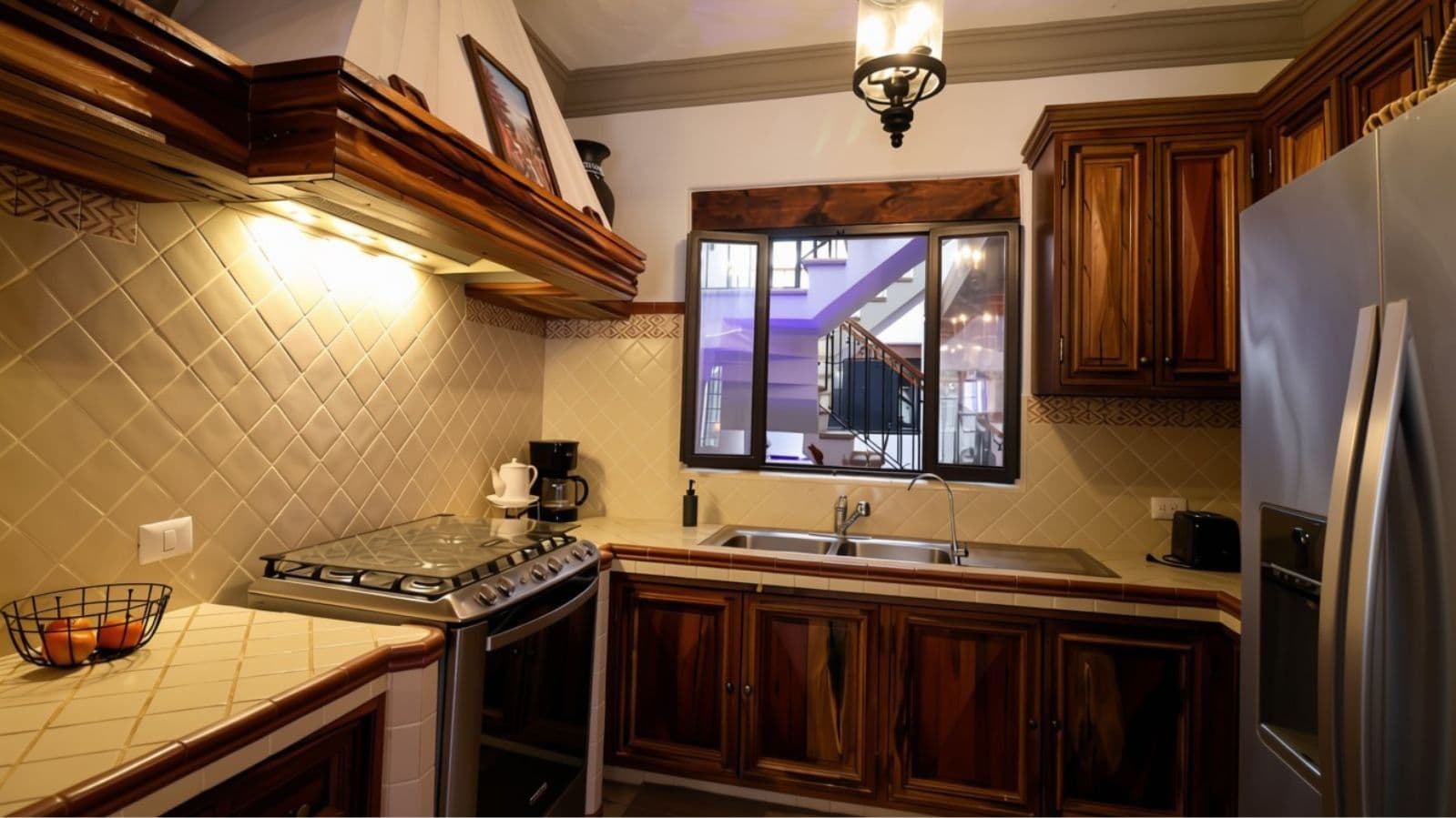 Casa Cocuchas — San Antonio, San Miguel de Allende — photo 12 — elegant traditional kitchen, warm wood cabinetry
