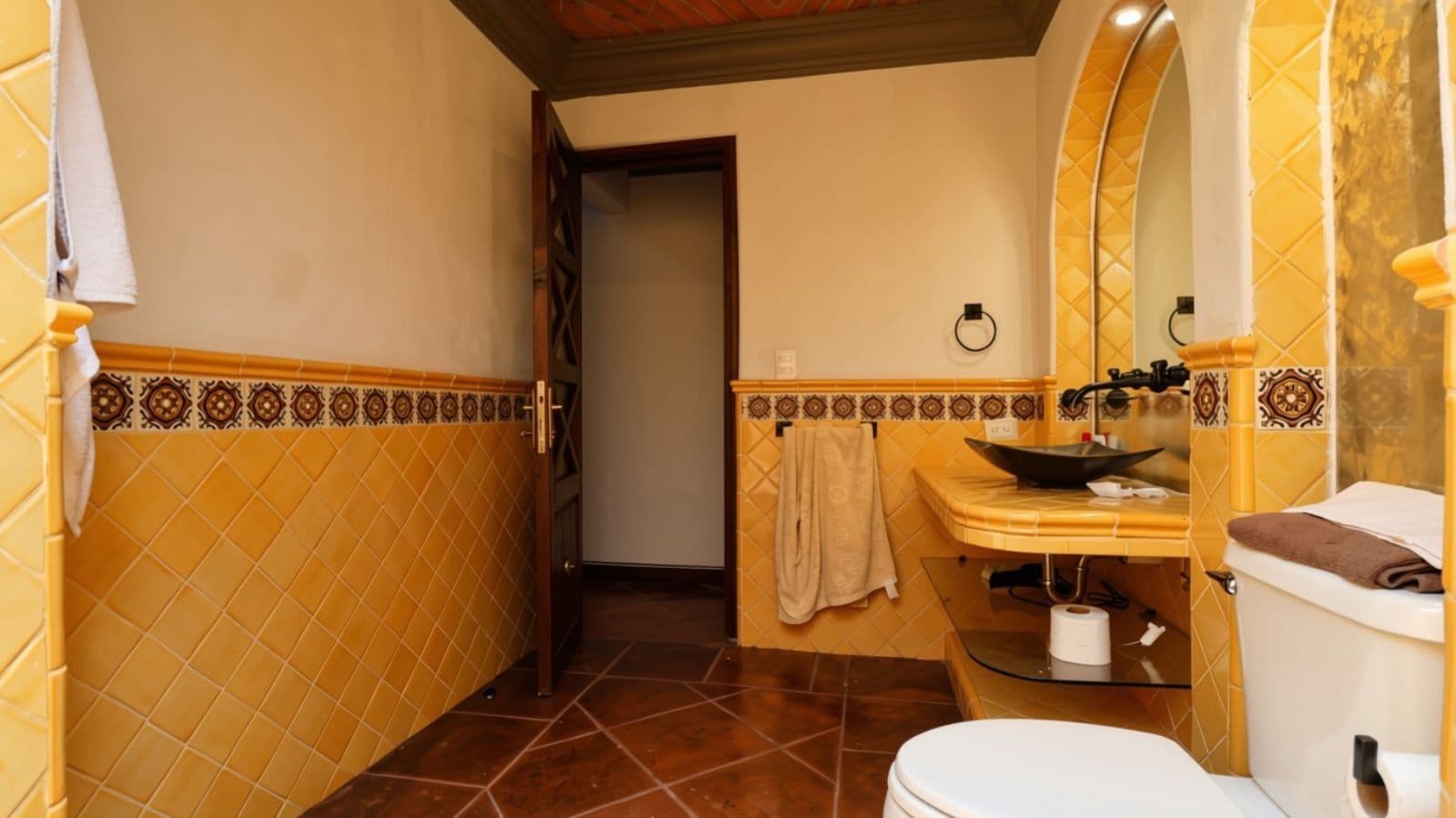 Casa Cocuchas — San Antonio, San Miguel de Allende — photo 18 — warm golden-tiled spa bathroom