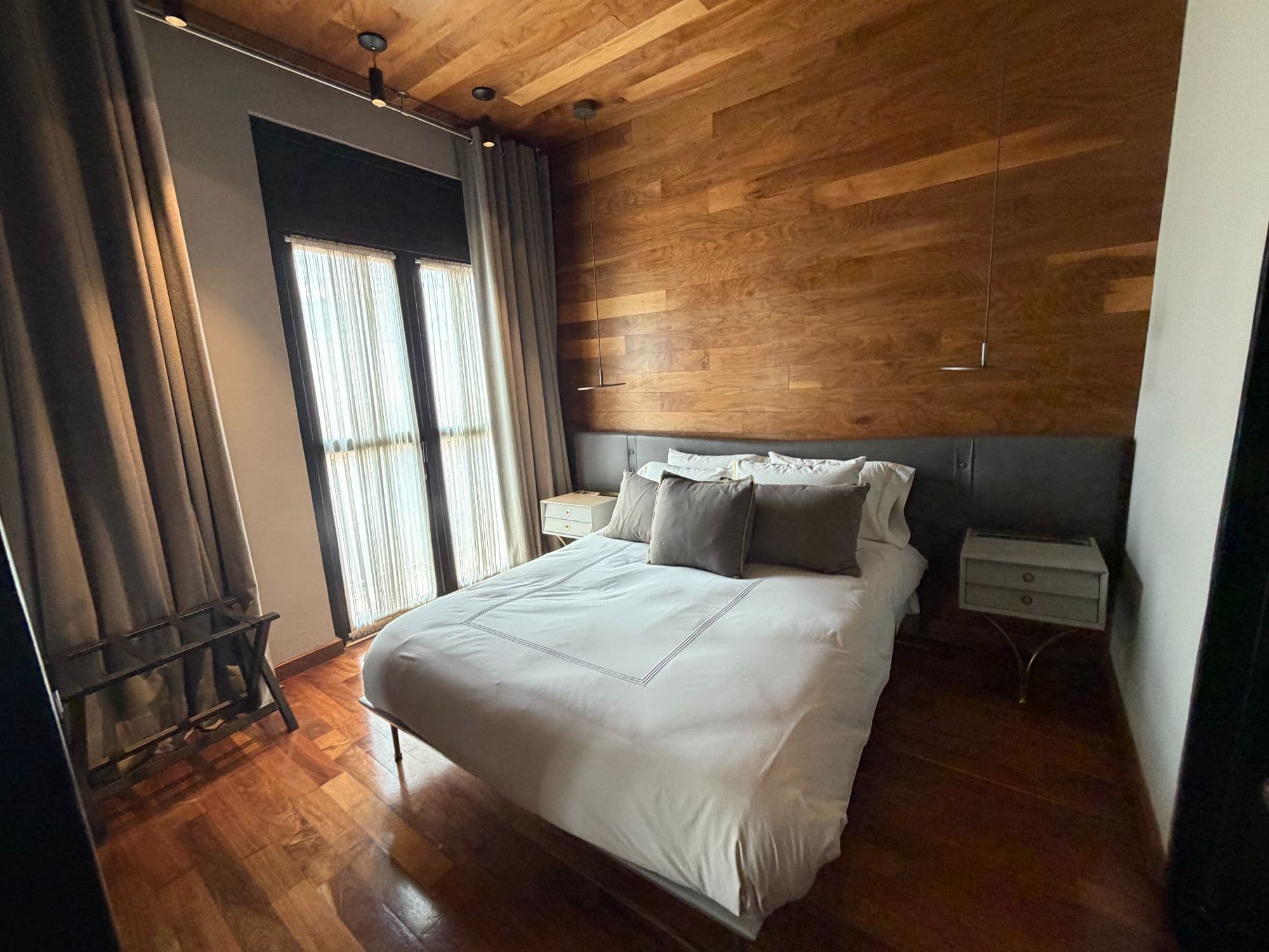 Departamento Umarán — Centro, San Miguel de Allende — photo 3 — sophisticated bedroom with warm wood accents