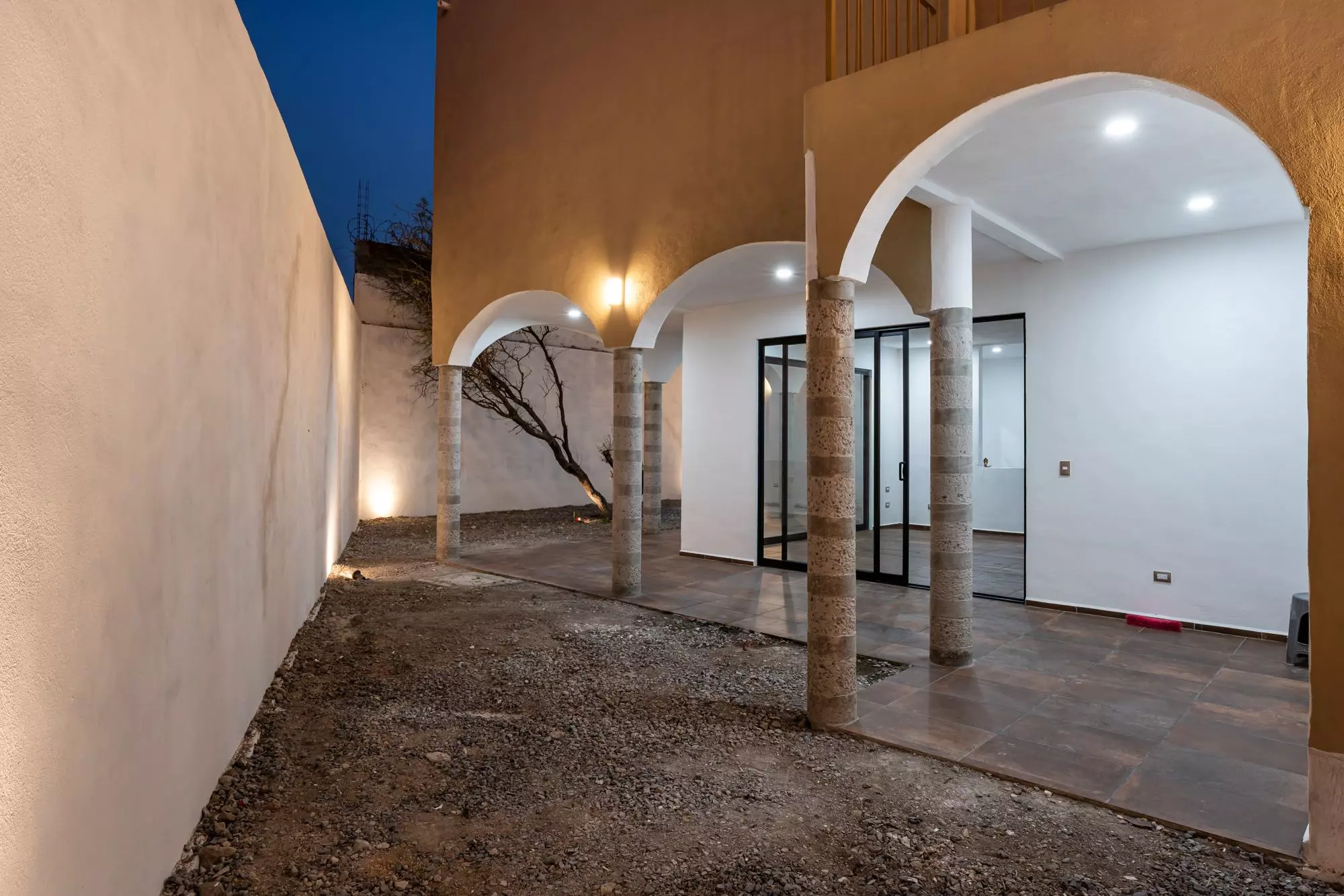 Casa Albor — La Palmita, San Miguel de Allende — photo 20 — elegant arched courtyard, atmospheric evening ambiance