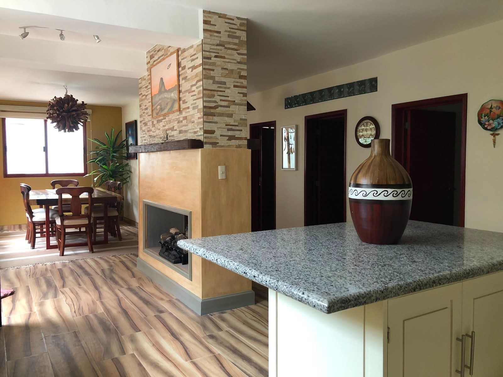 Casa Vista Carolina — Lindavista, San Miguel de Allende — photo 16 — modern open-concept living with fireplace