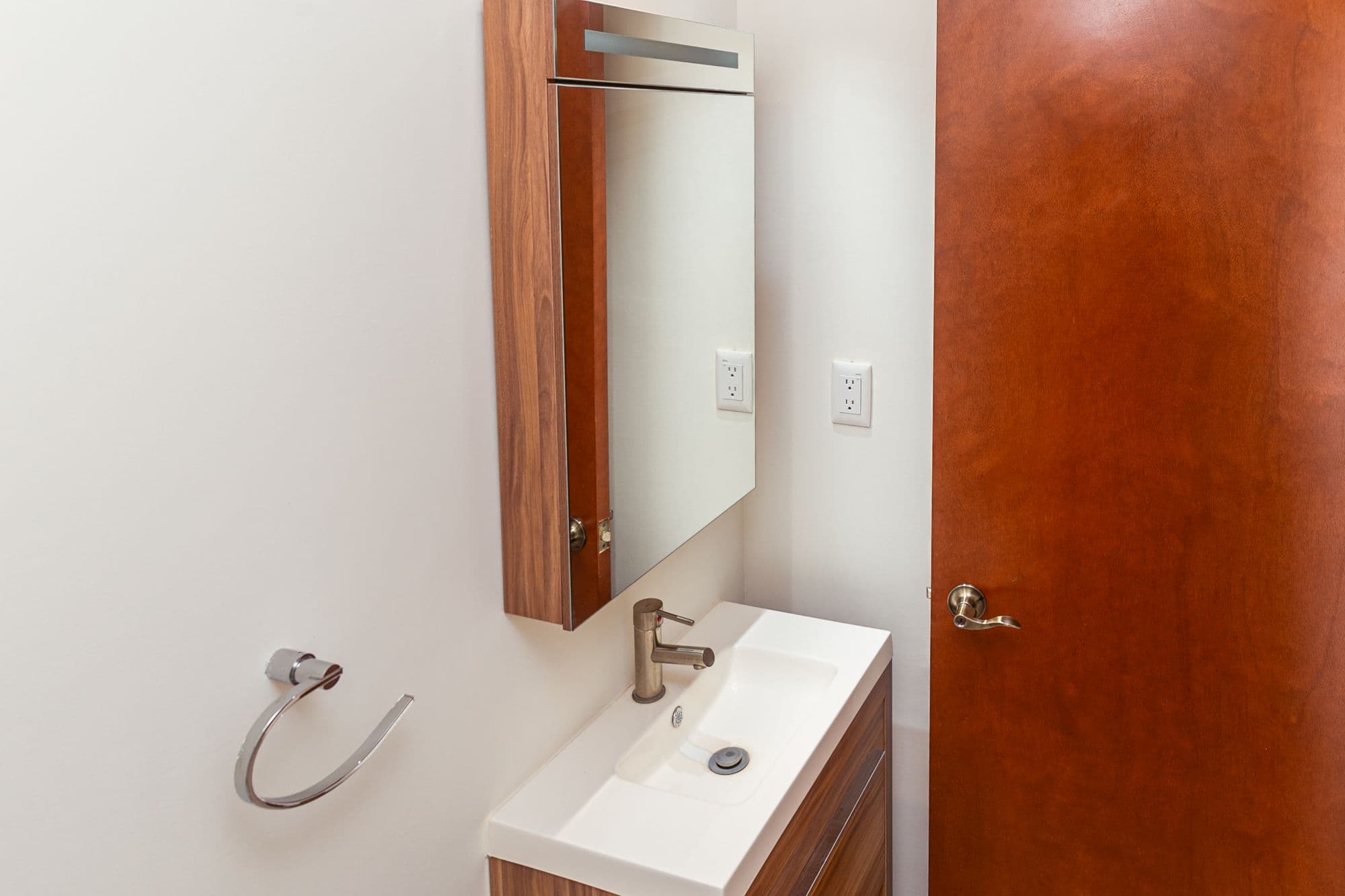 Casa Circuito El Reloj — Zirándaro, San Miguel de Allende — photo 26 — elegant modern vanity with warm wood finishes