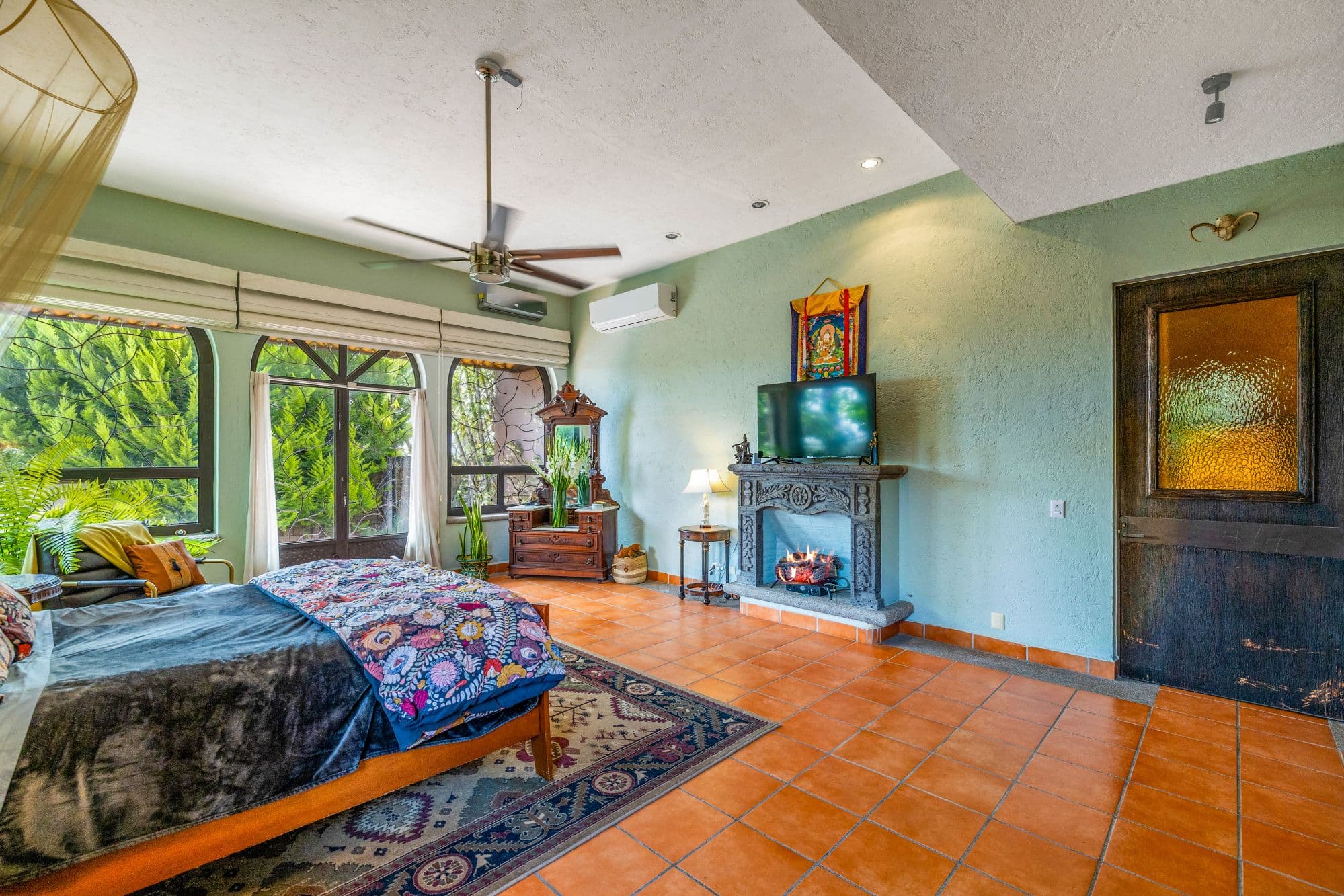 Casa Jardin Secreto — Los Labradores, San Miguel de Allende — photo 11 — luminous master suite with fireplace charm