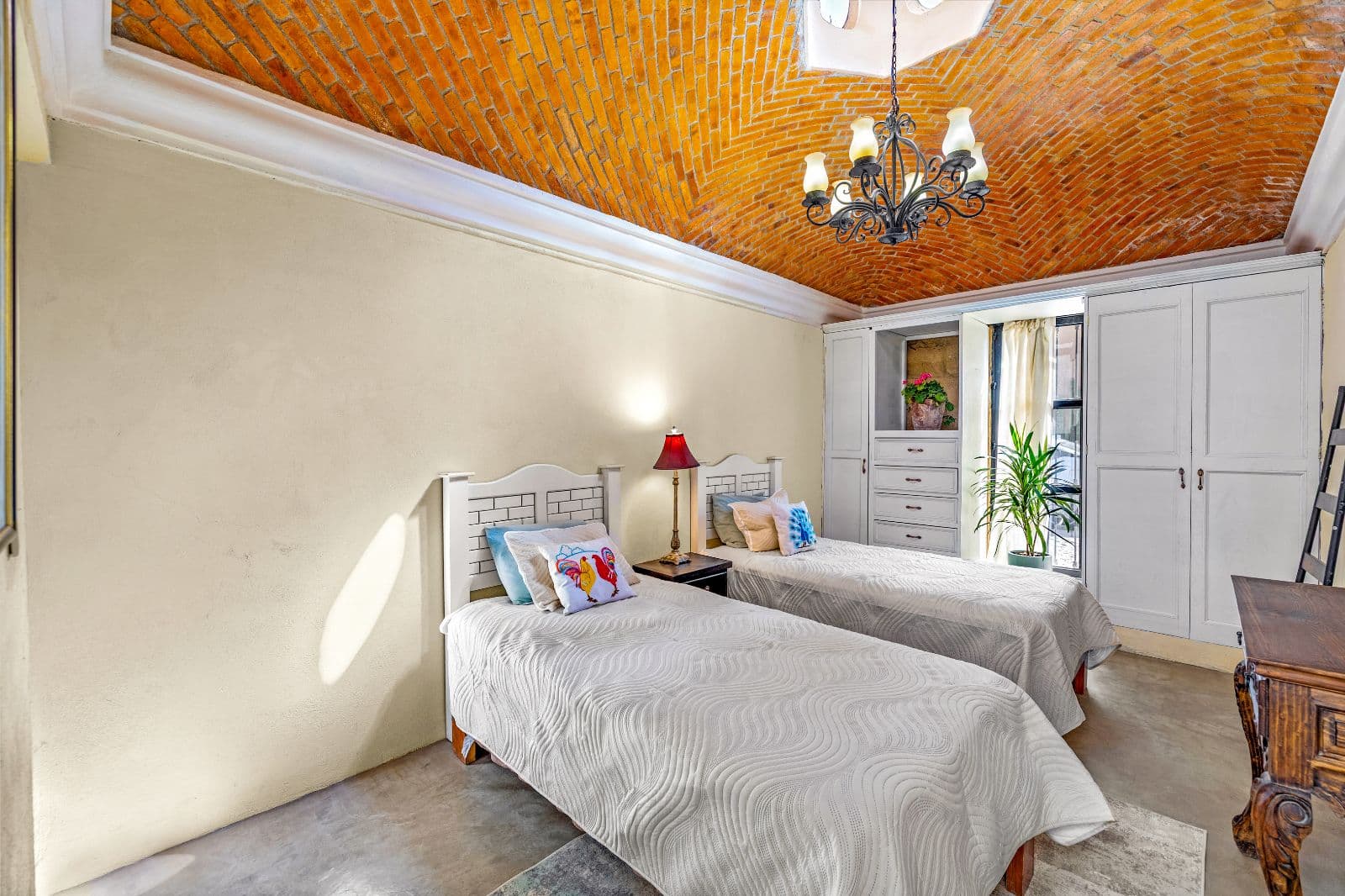 Casa Montitlan — Balcones, San Miguel de Allende — photo 10 — elegant bedroom with soaring brick ceiling