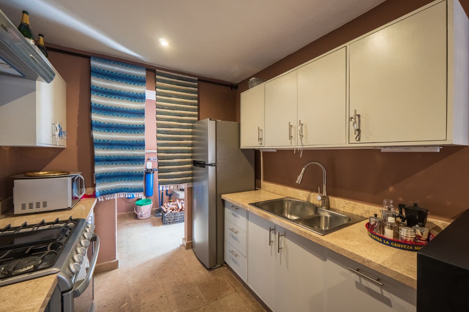 Casa Cielito Lindo — Guadalupe, San Miguel de Allende — photo 6 — contemporary kitchen with warm ambiance