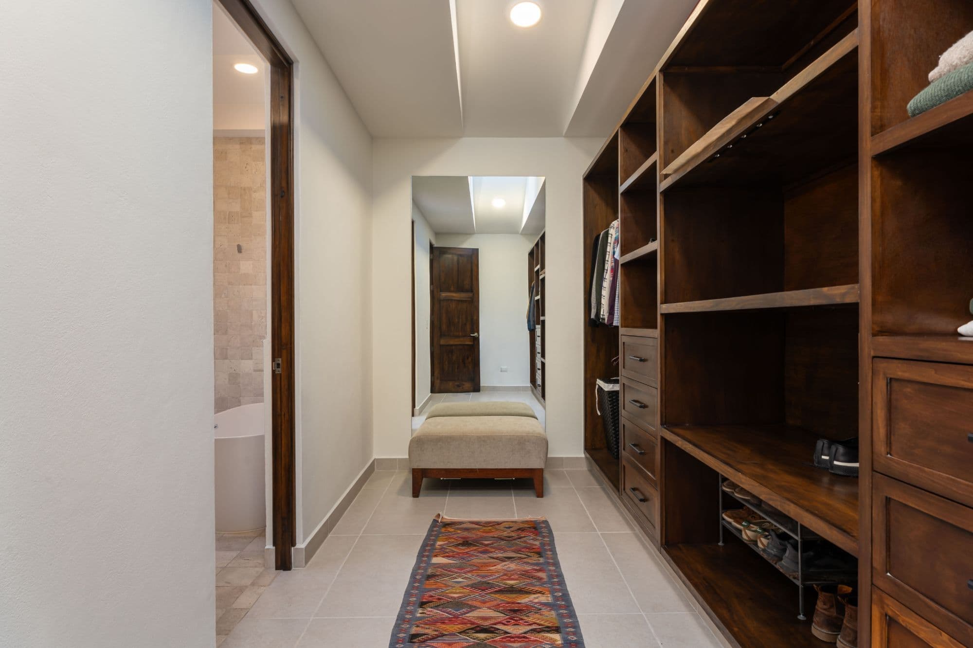 Casa Paulena — Balcones, San Miguel de Allende — photo 16 — elegant walk-in closet with refined wood cabinetry