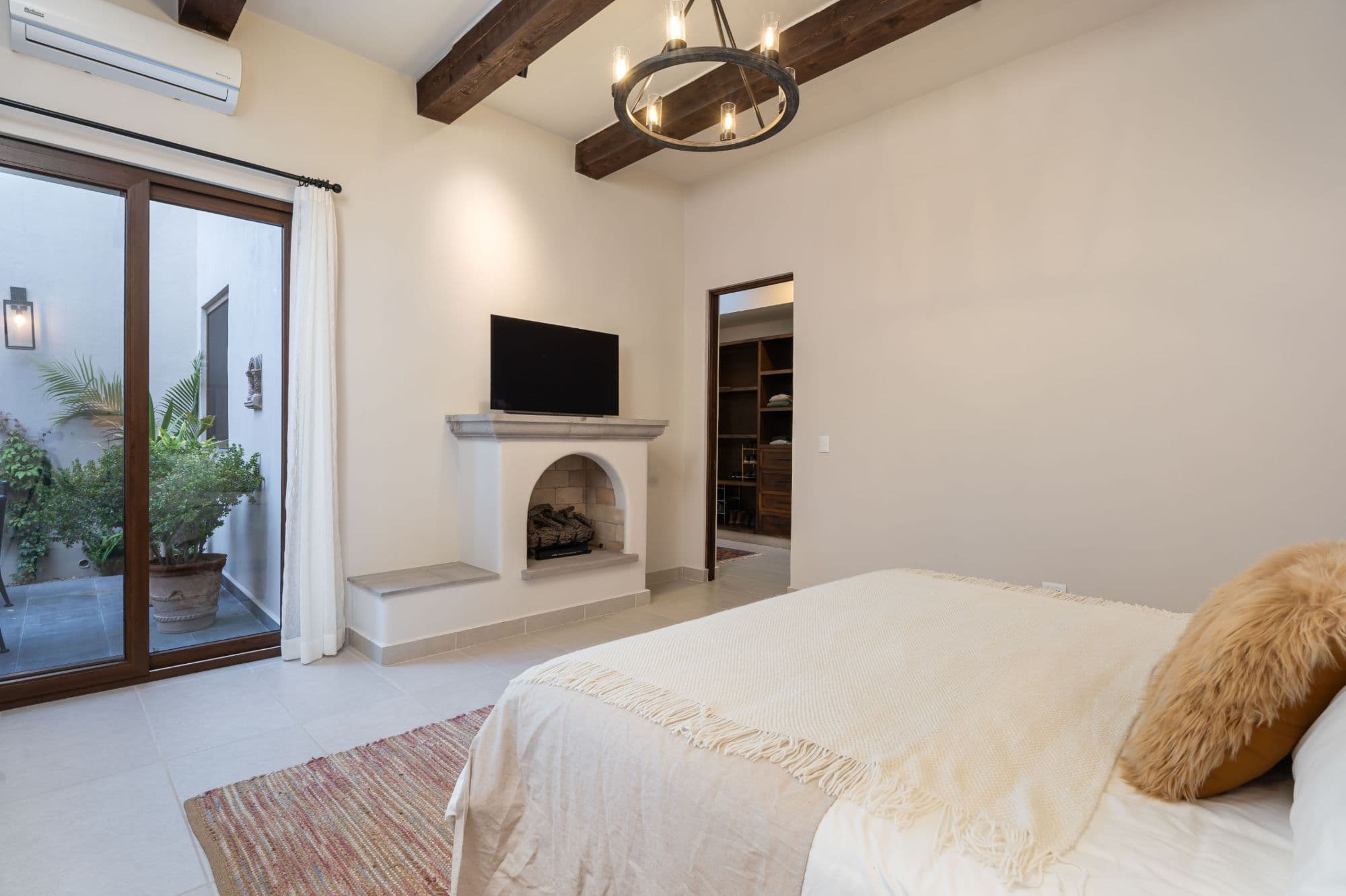 Casa Paulena — Balcones, San Miguel de Allende — photo 12 — serene master suite, fireplace warmth, courtyard views