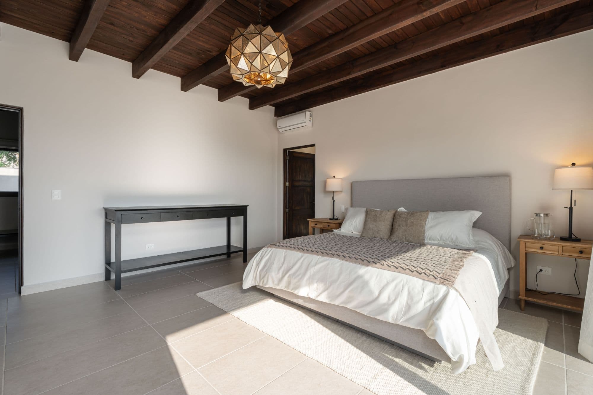 Casa Paulena — Balcones, San Miguel de Allende — photo 27 — serene master suite, exposed beams, natural light