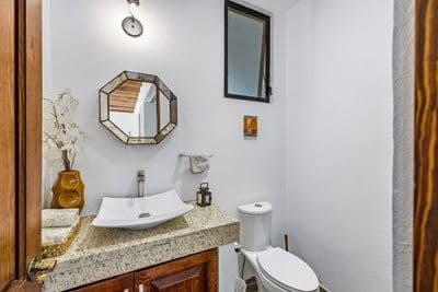 Casa Pial — Centro, San Miguel de Allende — photo 16 — elegant guest bath, refined finishes