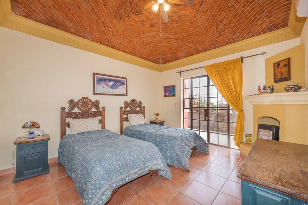 Casa Trueno — La Lejona, San Miguel de Allende — photo 12 — charming colonial bedroom with terracotta details