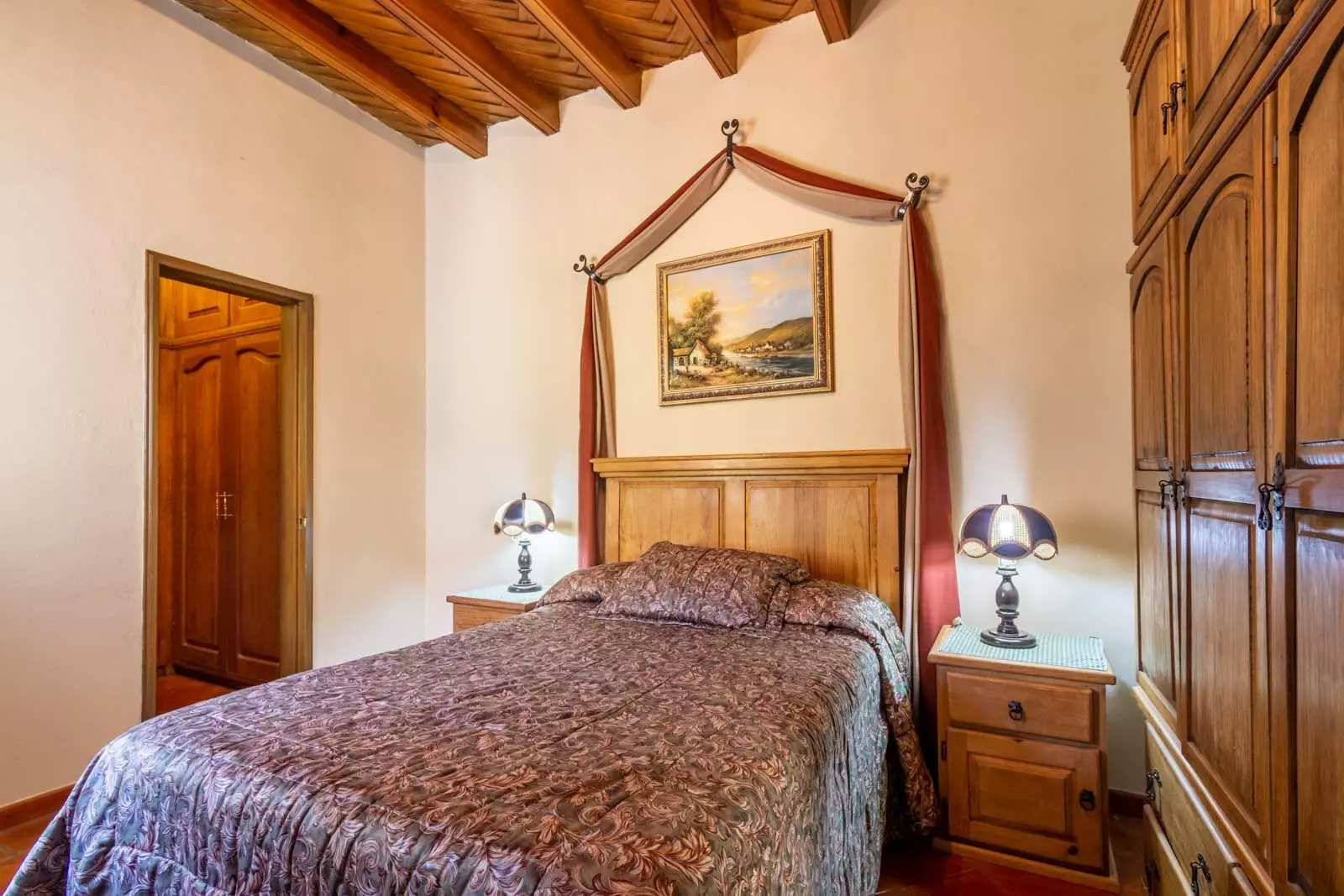 Agua Homes — Atascadero (Arcos de San Miguel), San Miguel de Allende — photo 16 — elegant canopy bed, rustic timber ceiling