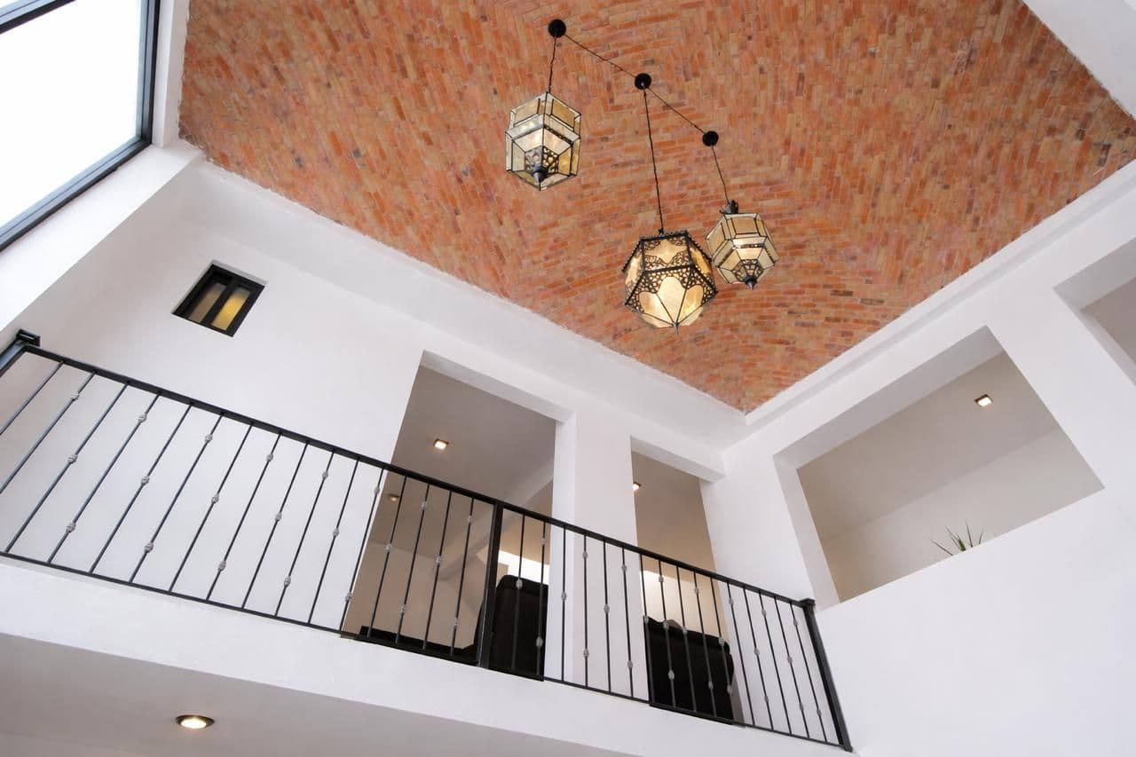 CASA DEL PUENTE DE UMARÁN — Centro, San Miguel de Allende — photo 4 — soaring brick vault, artisan pendant lighting