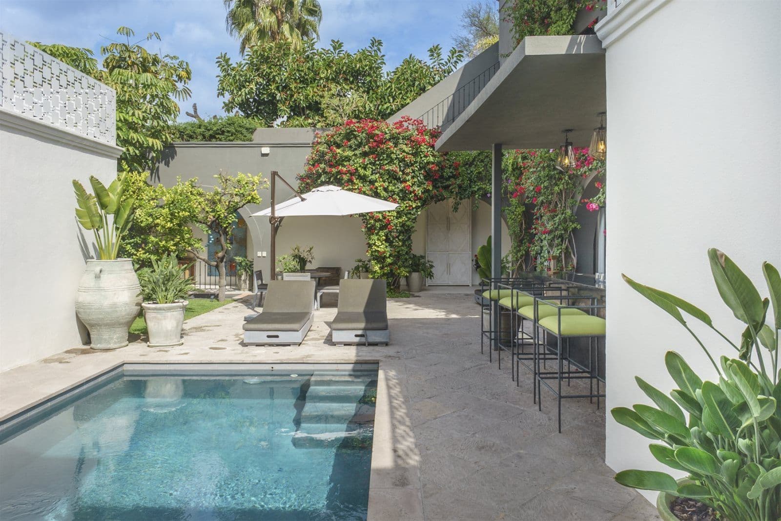Casa Arcadia — Centro, San Miguel de Allende — photo 11 — serene poolside oasis, vibrant blooms flourish