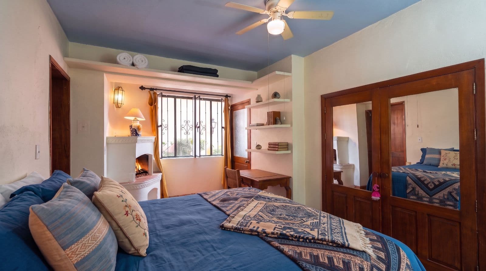 Condo Lelé — Centro, San Miguel de Allende — photo 16 — sunlit master suite, fireplace warmth awaits